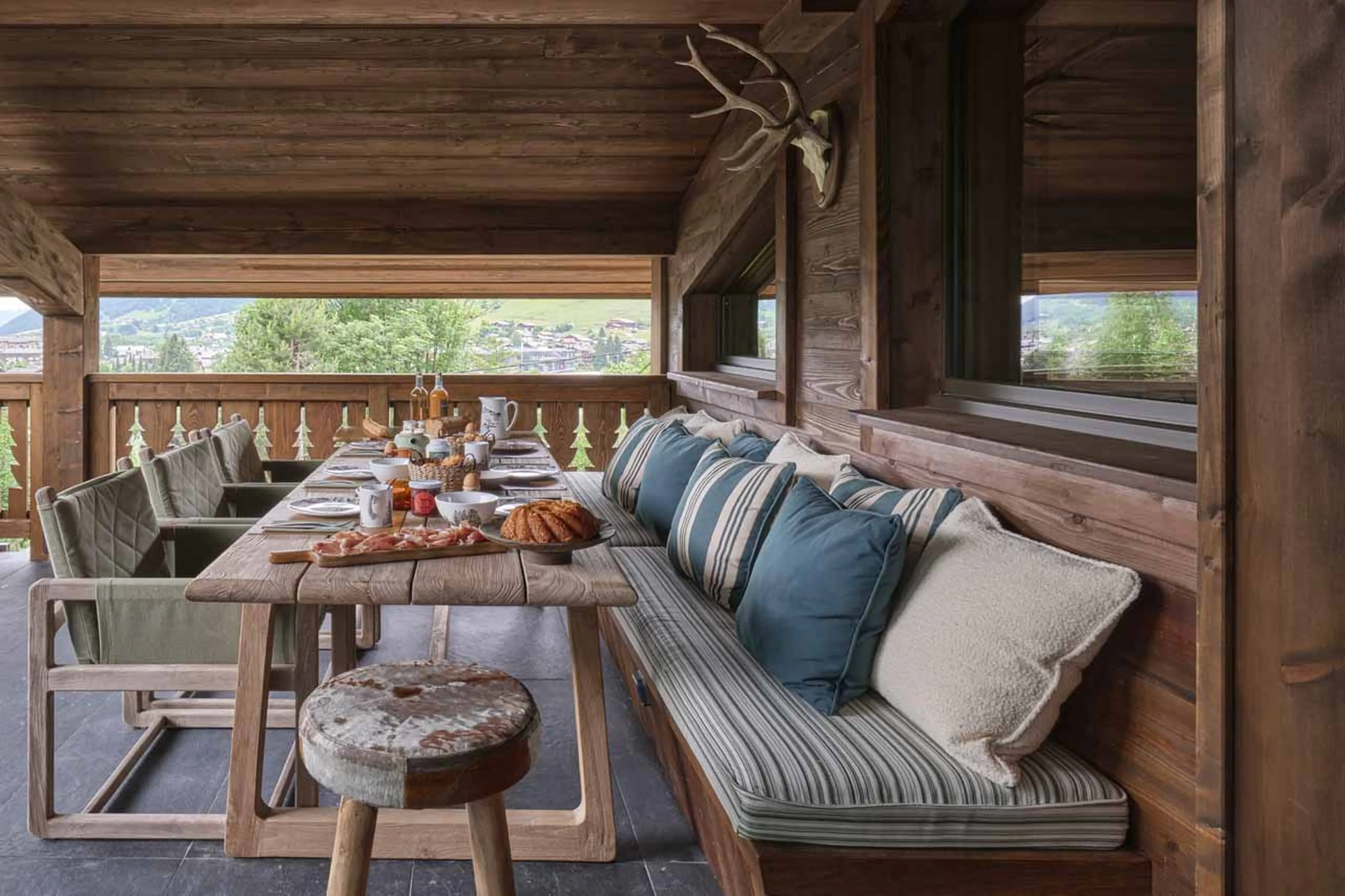 Balcony seating and table at Chalet Le Molitor in Megeve