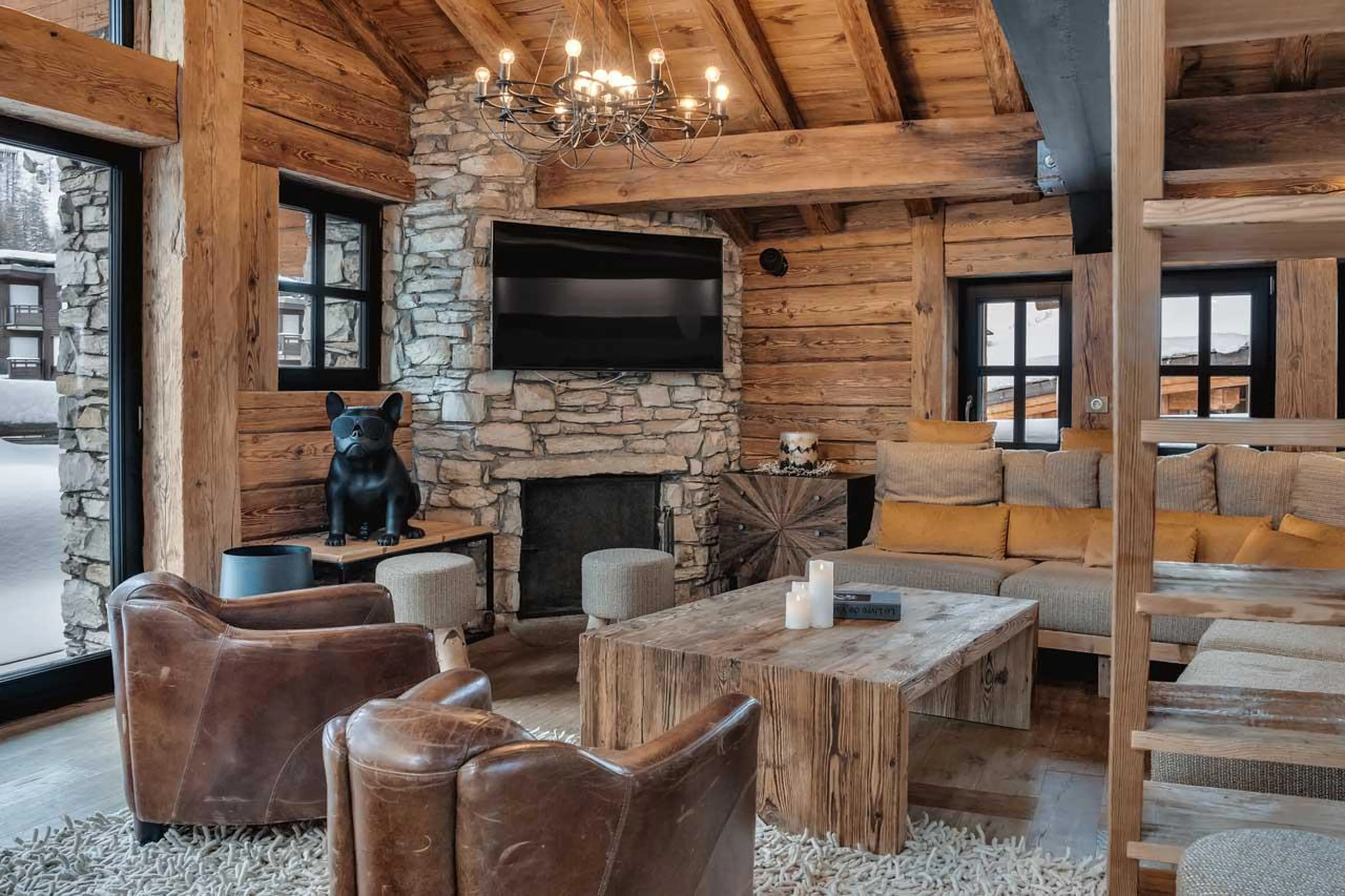 Open-plan living space with cosy sofa corner at Chalet Le Papillon in Val d'Isere