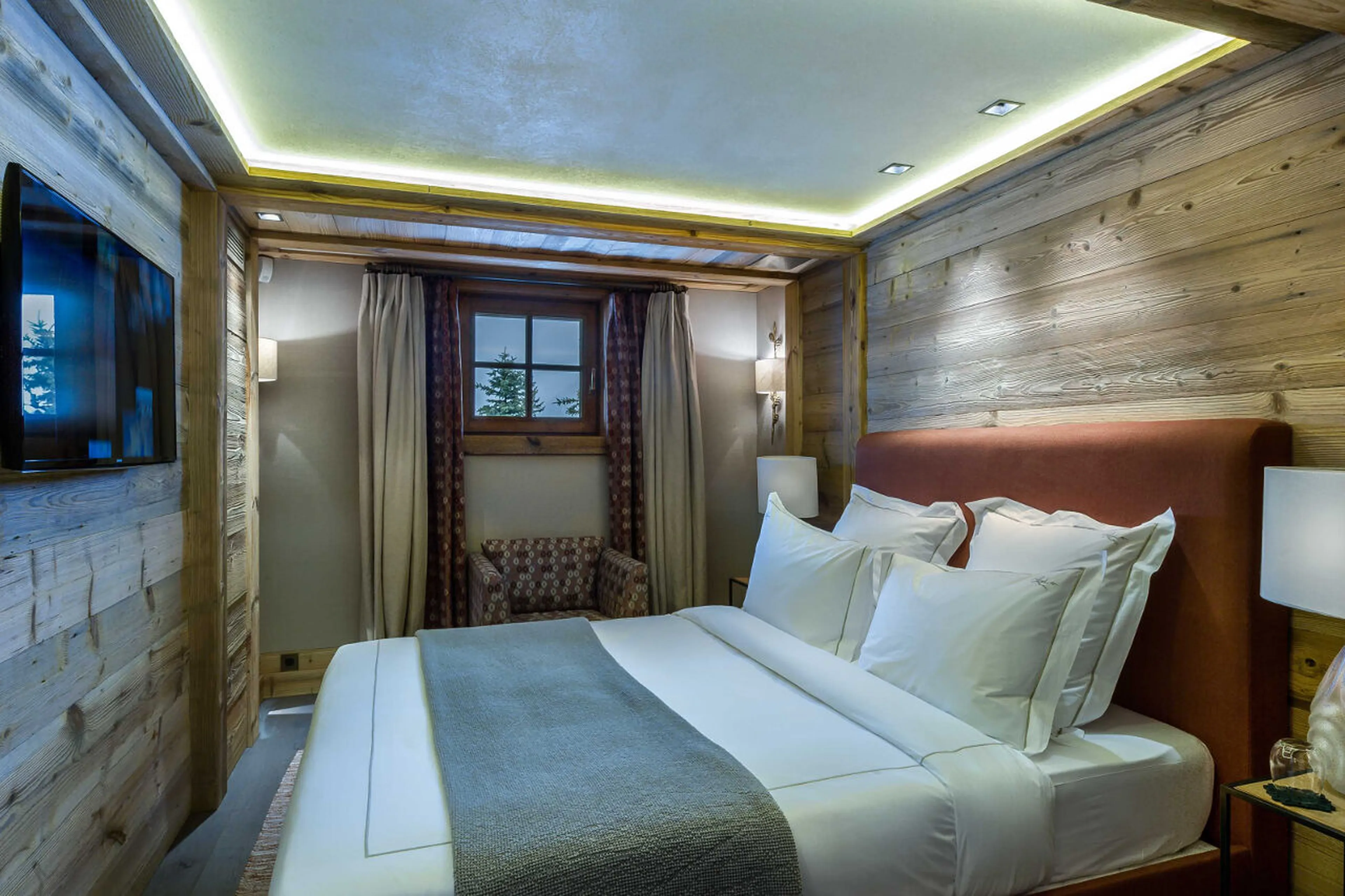 Bedroom with double bed, dressing area, en suite shower room in Chalet Les Bastidons  in Courchevel
