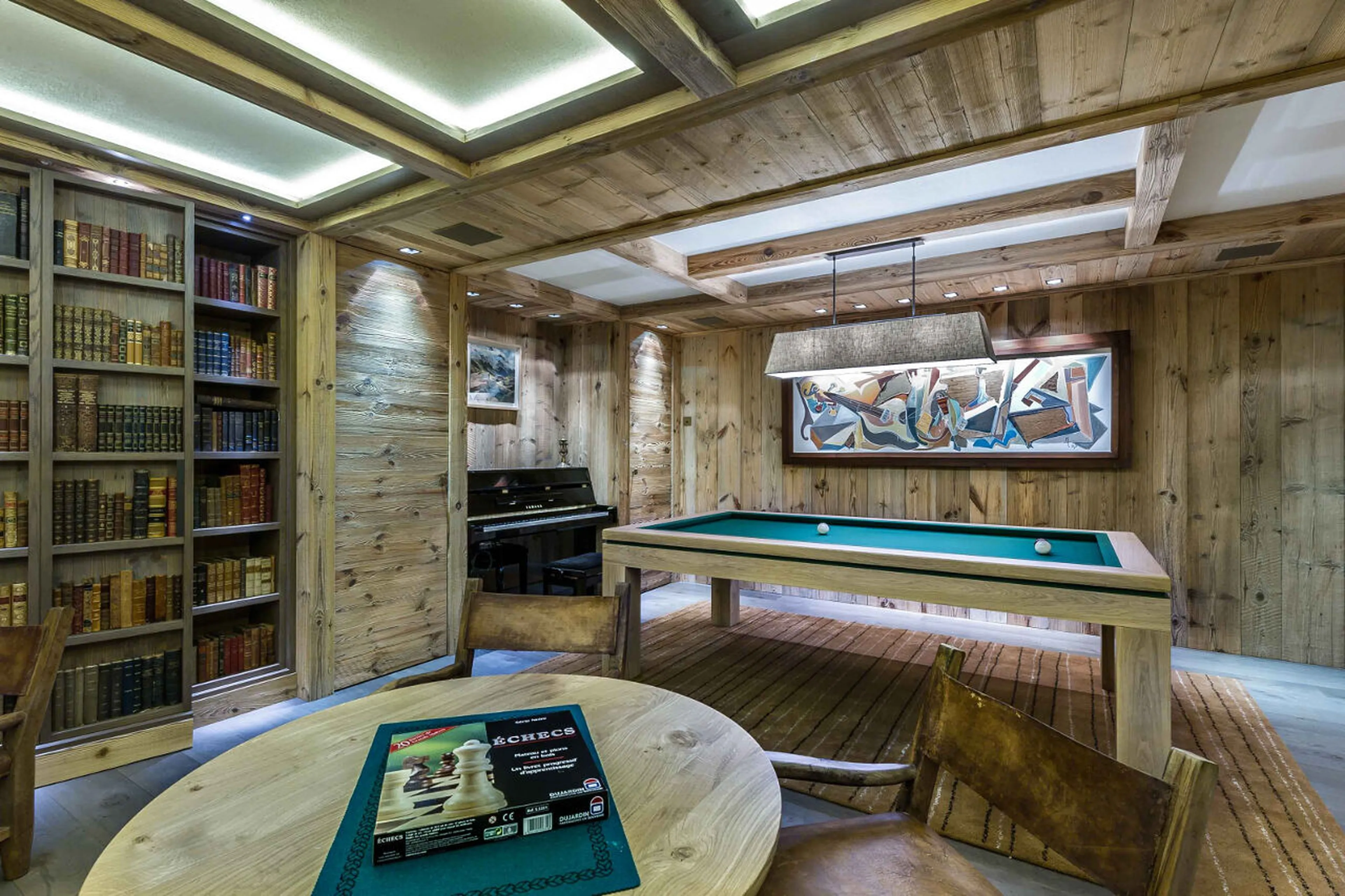 Books, piano and pool table in games room of Chalet Les Bastidons  in Courchevel 1850