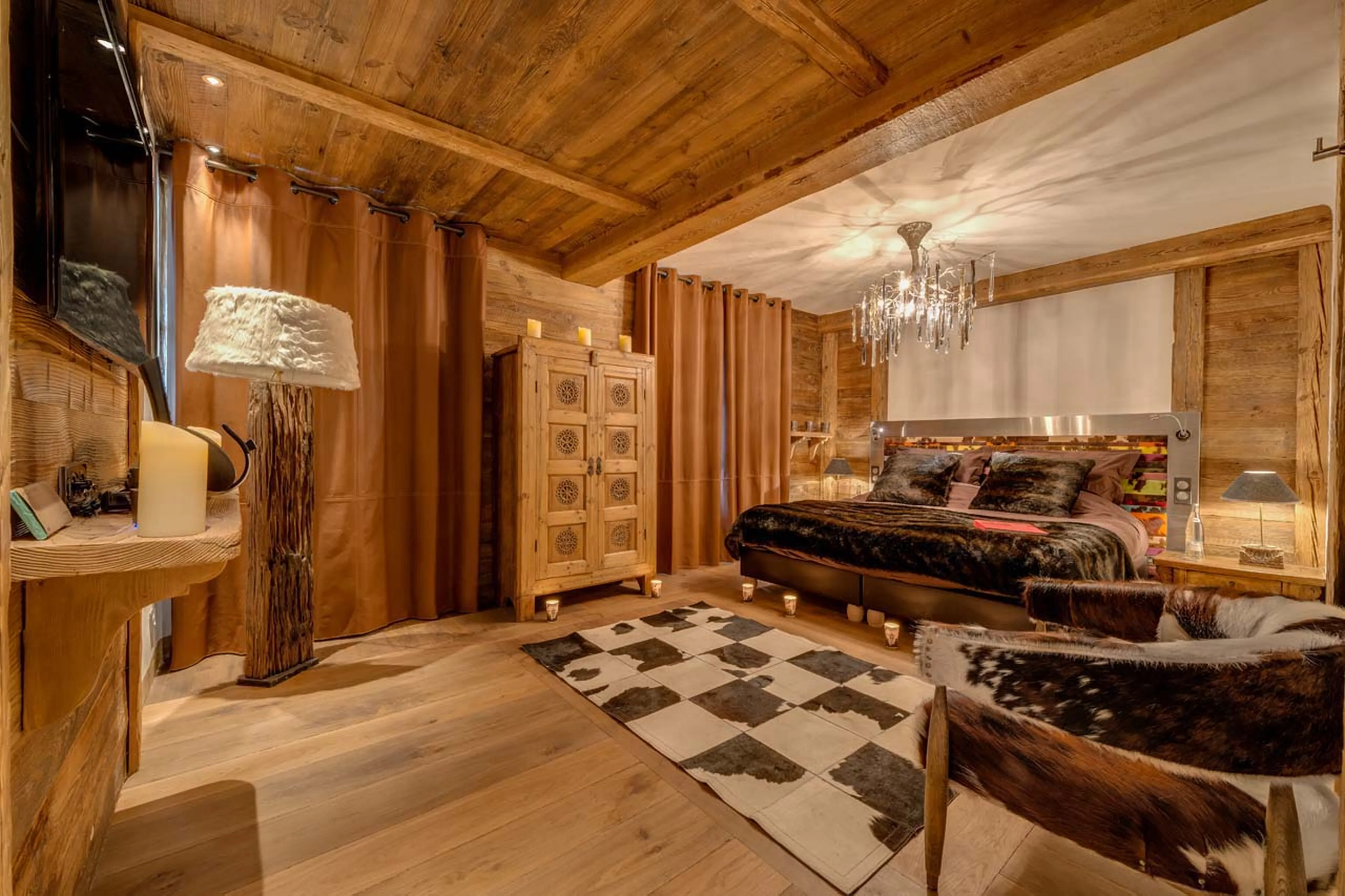Double bedroom with seating area, terrace access and en suite shower room in Chalet Lhotse in Val d’