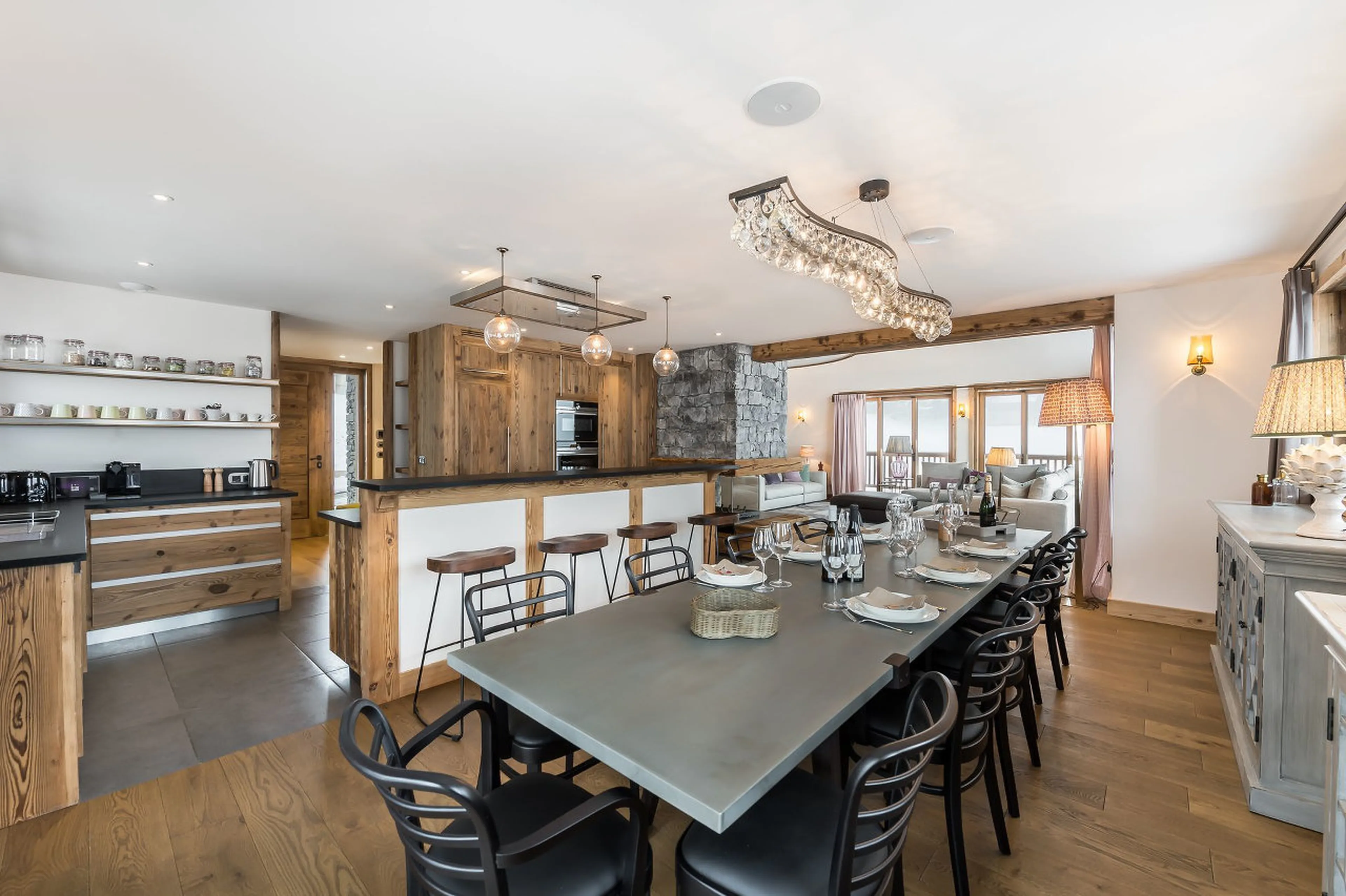 Dining area and kitchen with breakfast bar in Chalet Libellule in Courchevel 1650