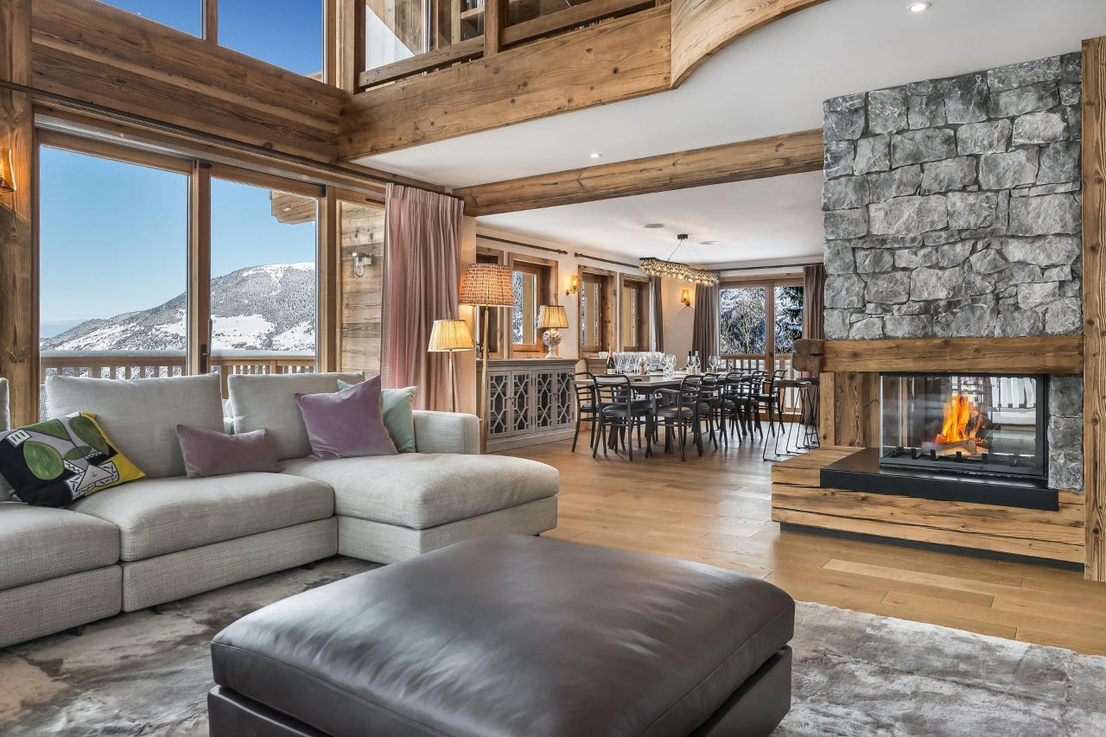 Open living area with central fireplace in Chalet Libellule in Courchevel 1650