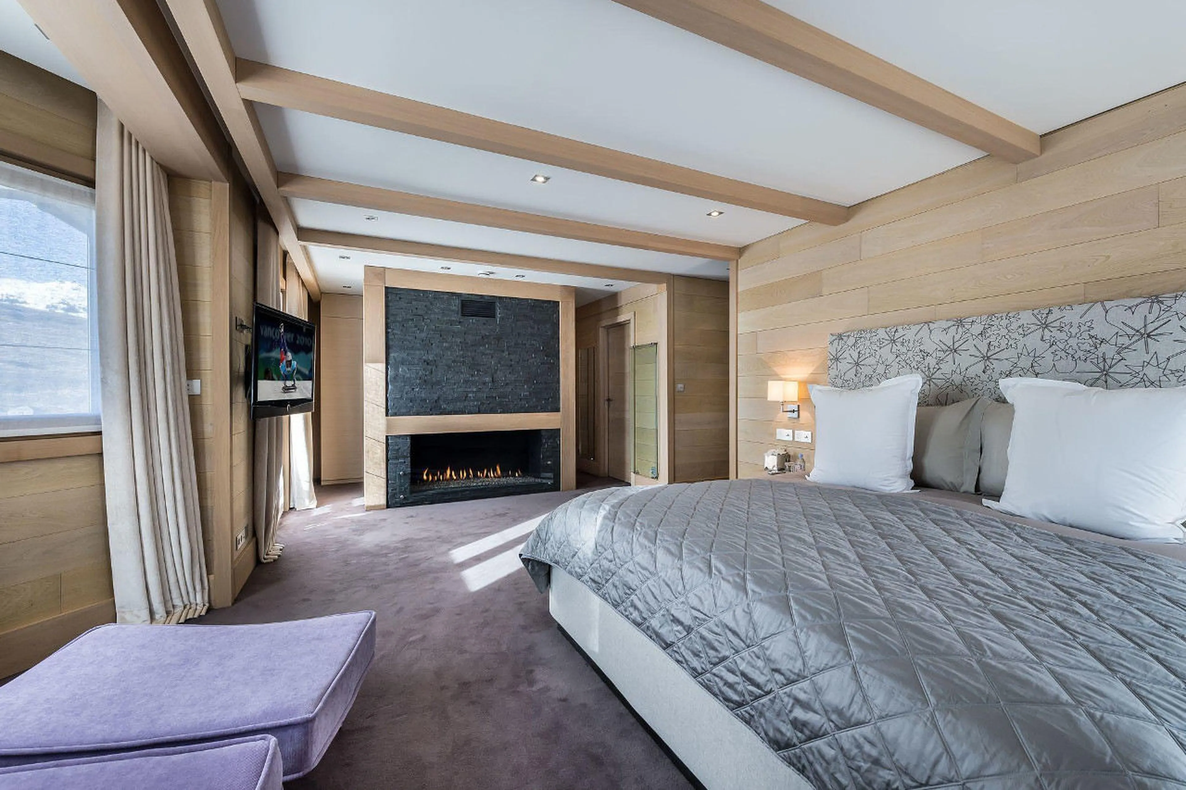 Double bedroom with ethanol fireplace in Chalet Licorne in Courchevel 1650
