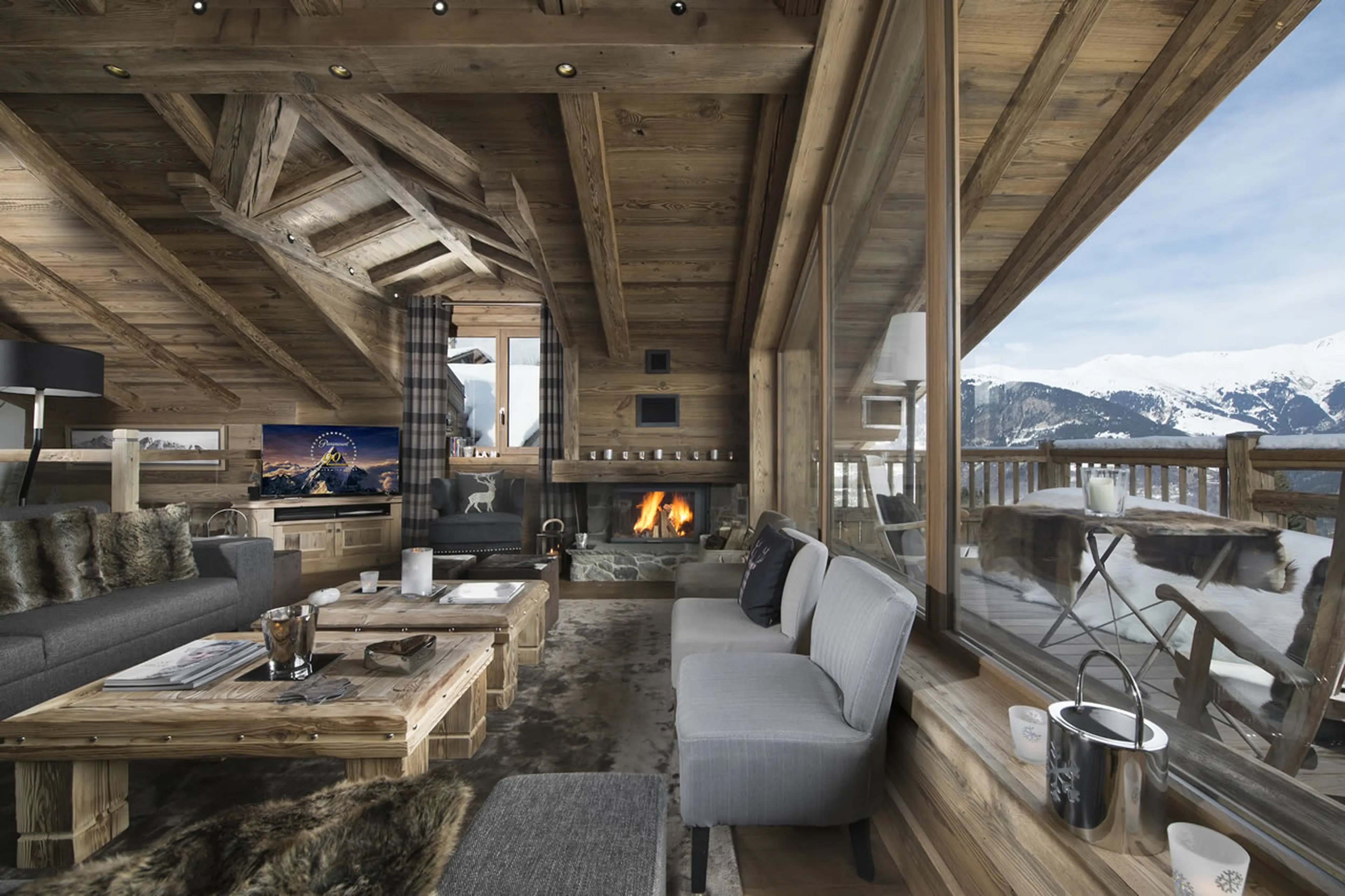 Open plan living room with vaulted ceiling, view and balcony access in Chalet M in Courchevel 1550