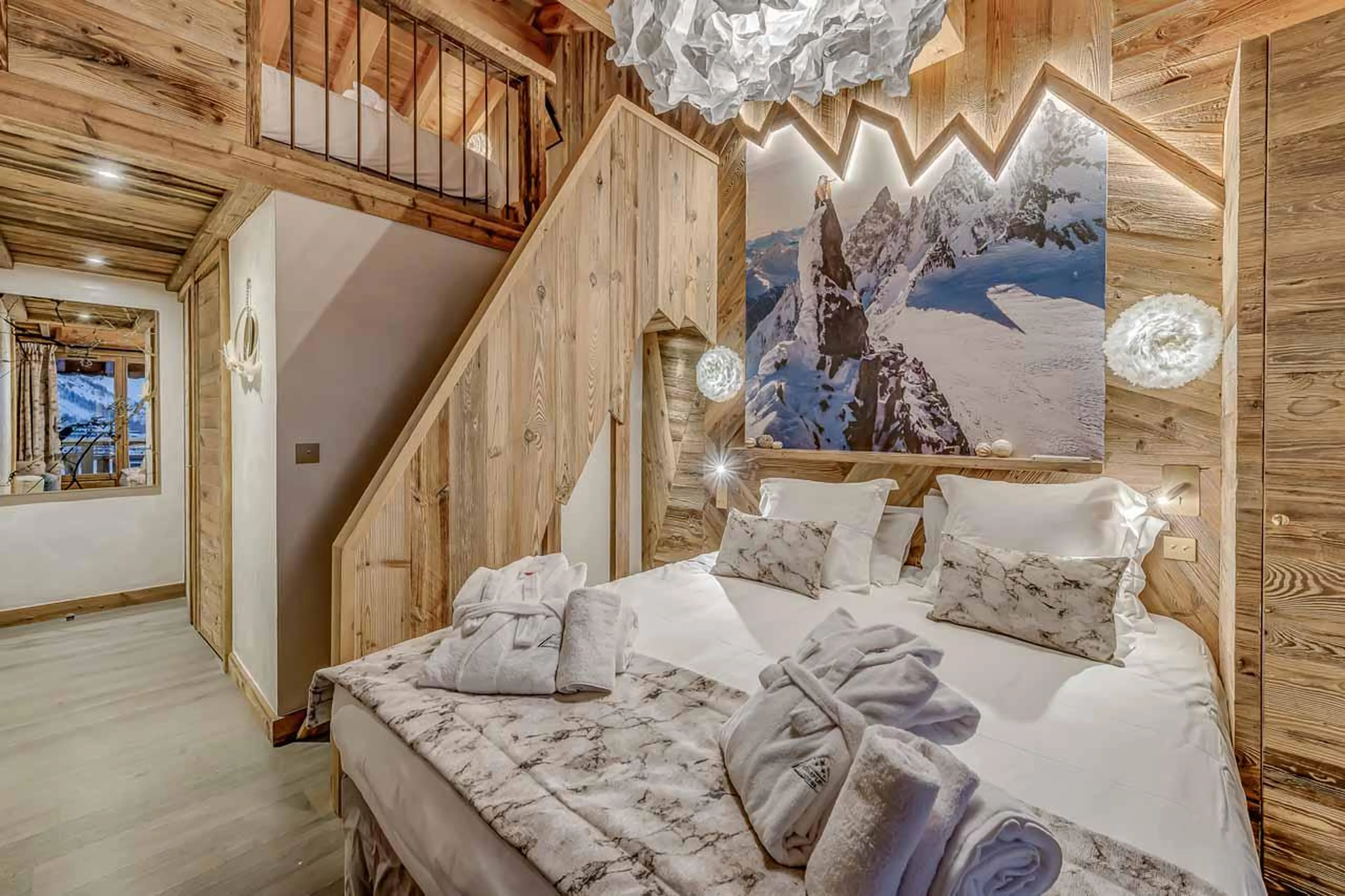 Double/twin bedroom with stairs to mezzanine at Chalet Macha in Tignes