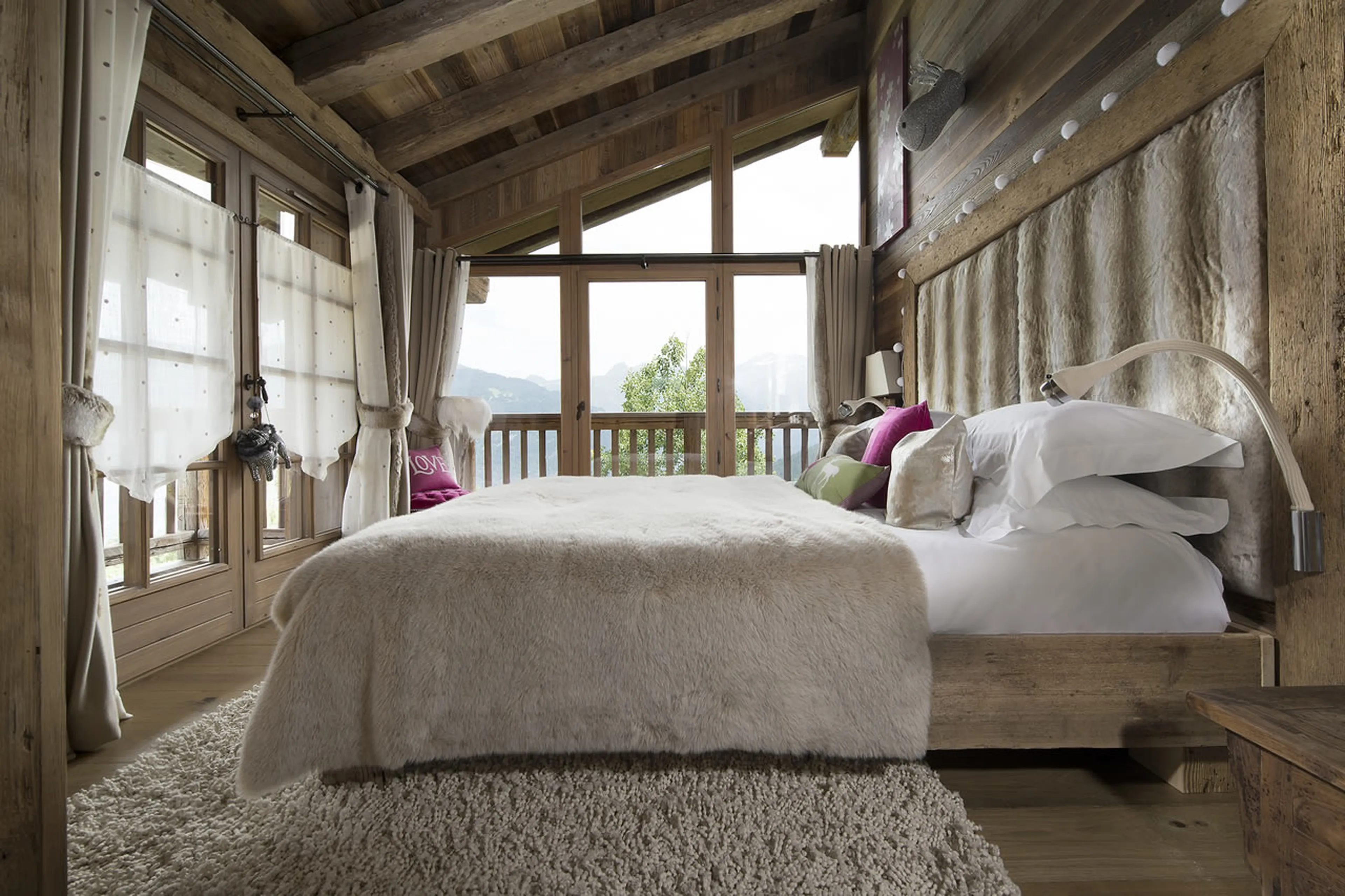 Double bed en-suite bedroom with access to balcony in Chalet Makalu in Courchevel 1550