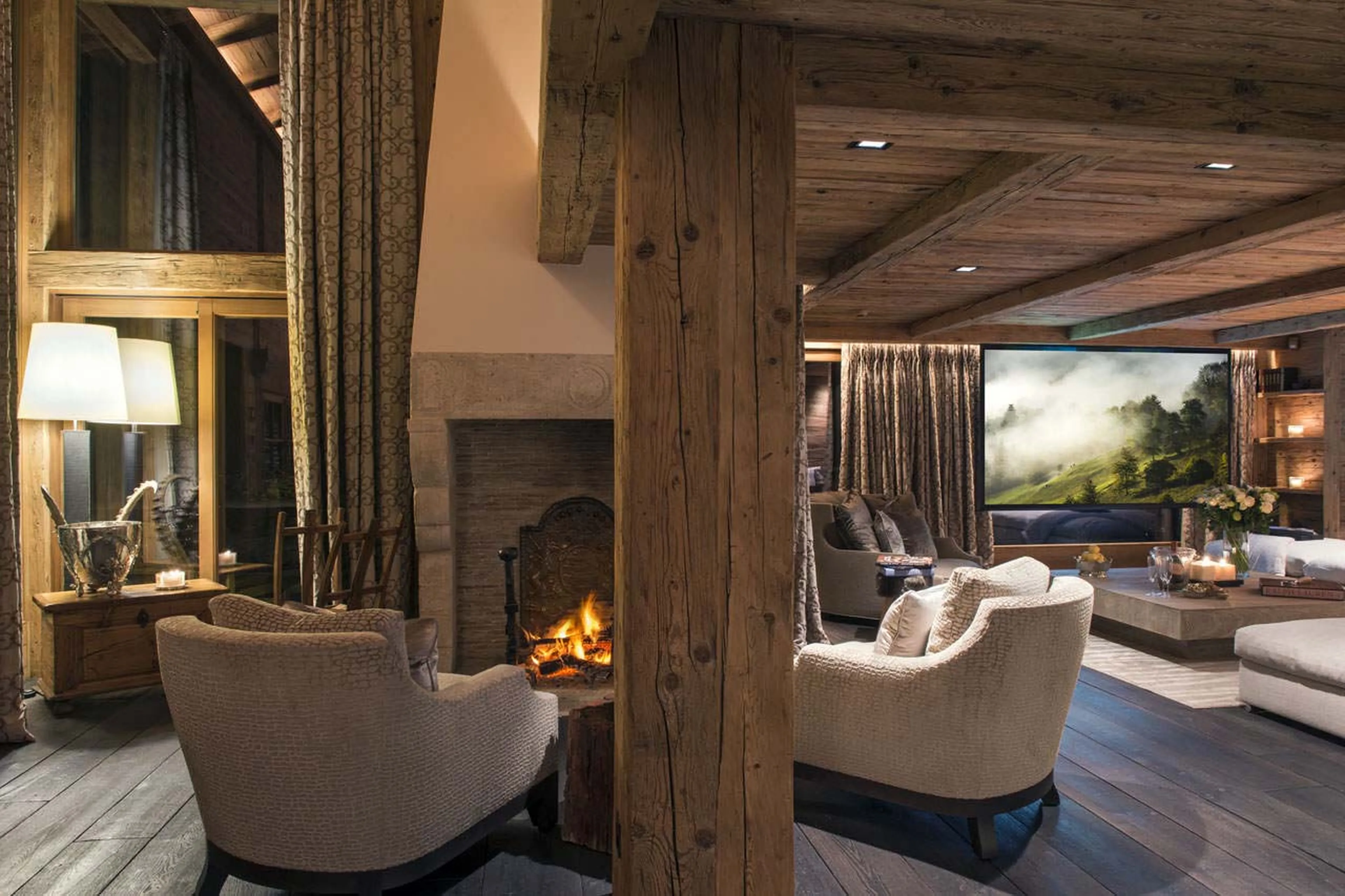 Armchairs beside fireplace of Chalet Makini in Verbier
