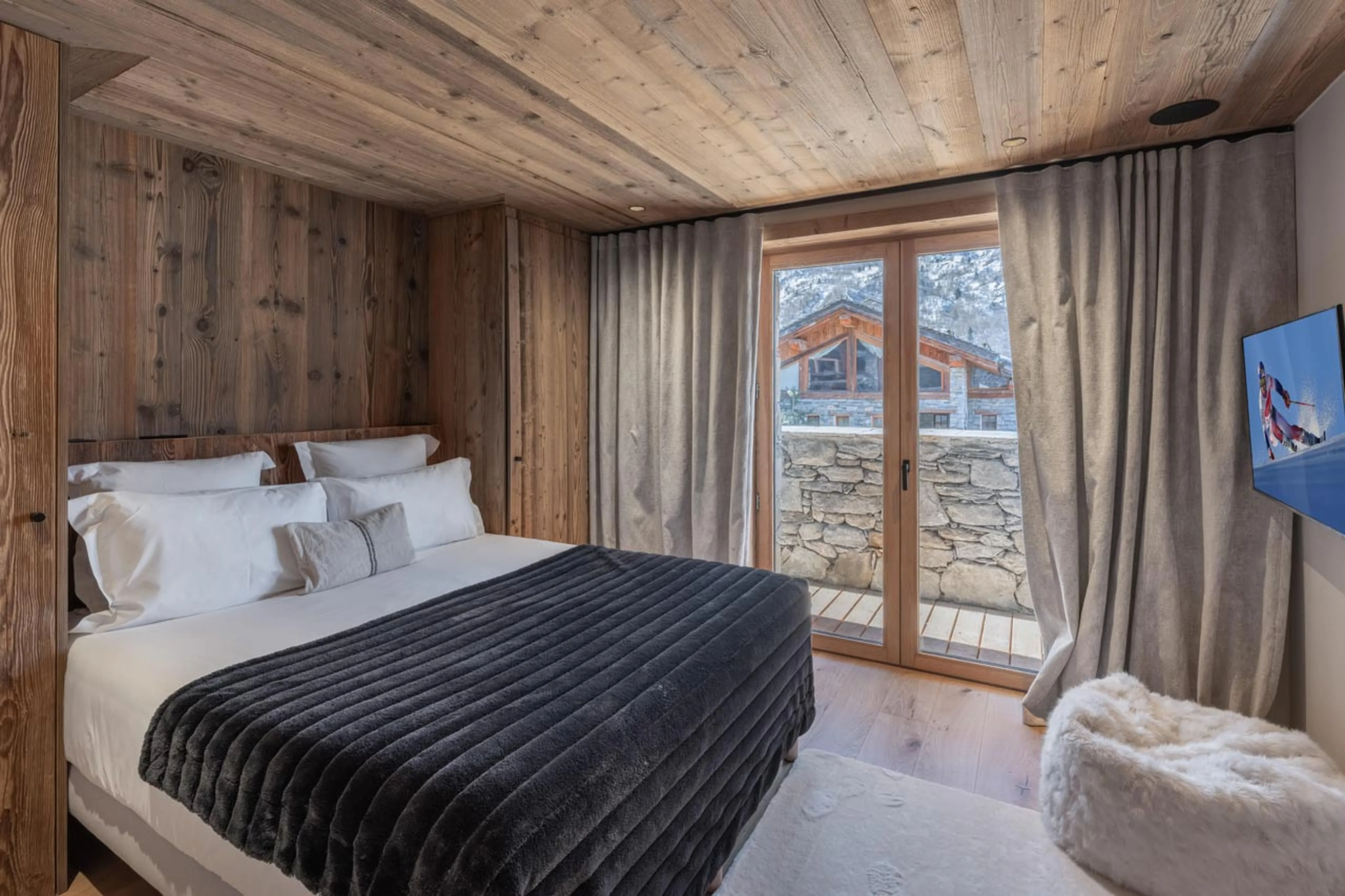 Double bedroom with glass doors in Chalet Marcel, St Martin de Belleville