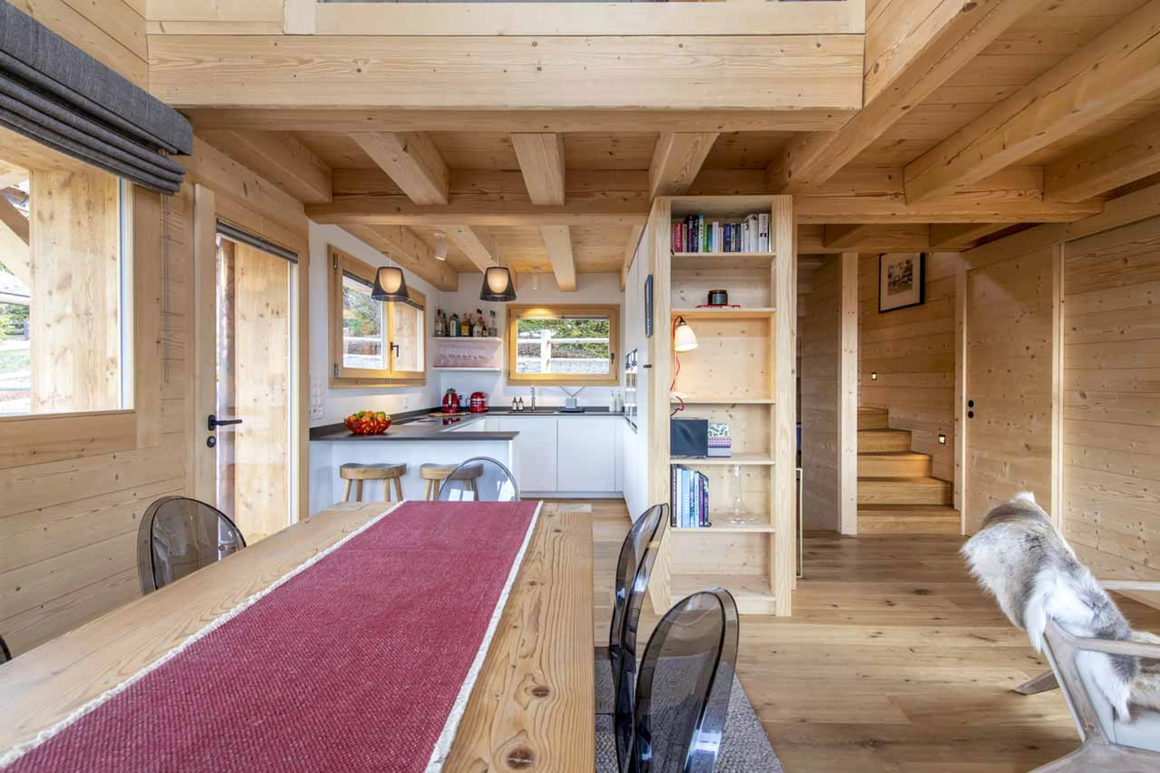 Dining table and kitchen at Chalet Melilot in Verbier