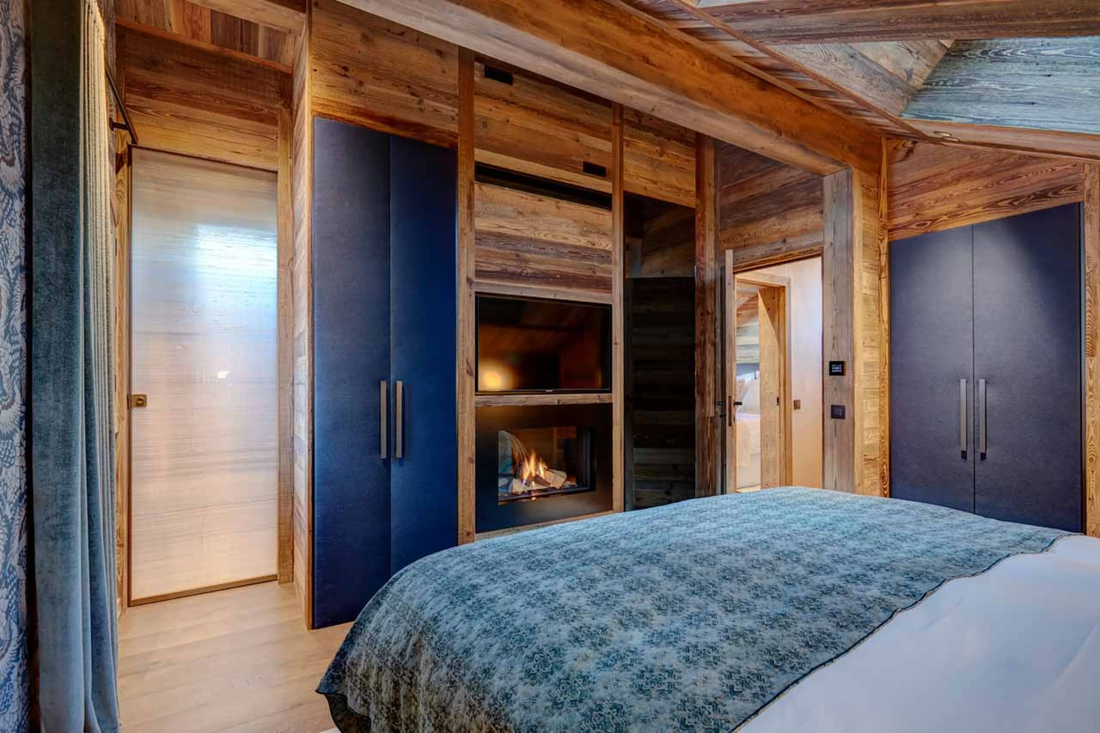 Fireplace and TV in master suite at Chalet Menor in Meribel