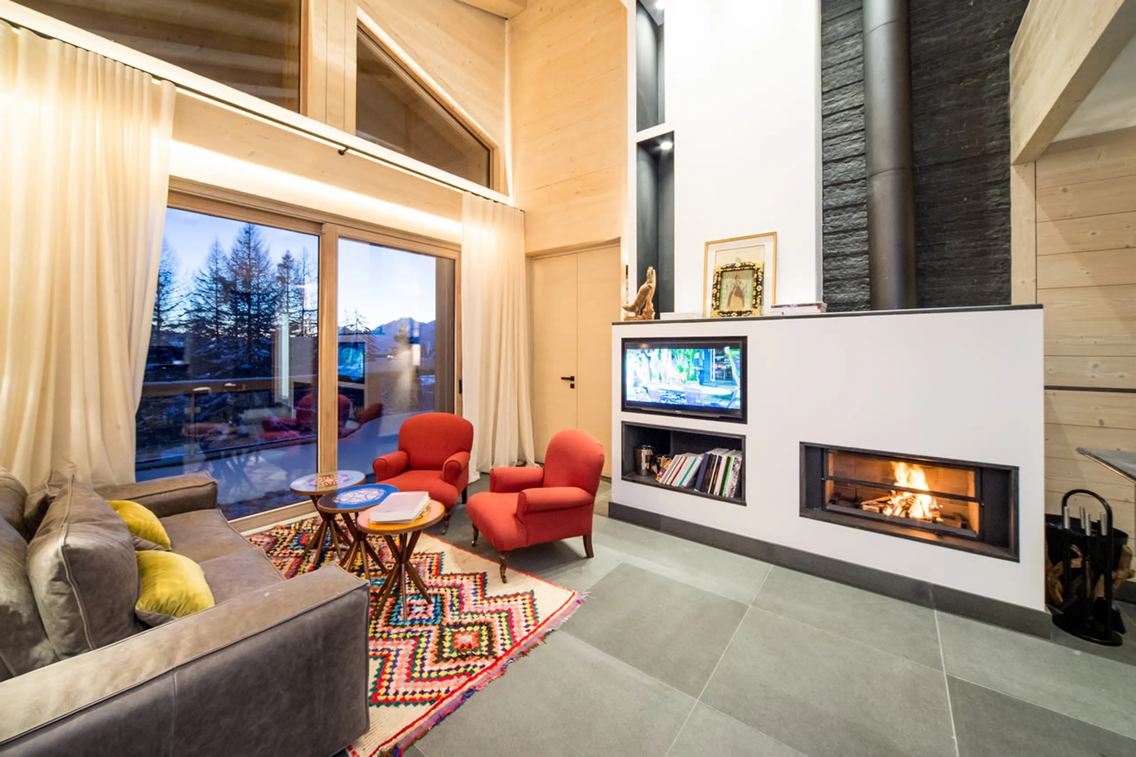Double height living room with balcony access of Apartment Bellalui in Chalet Migui in Crans-Montana