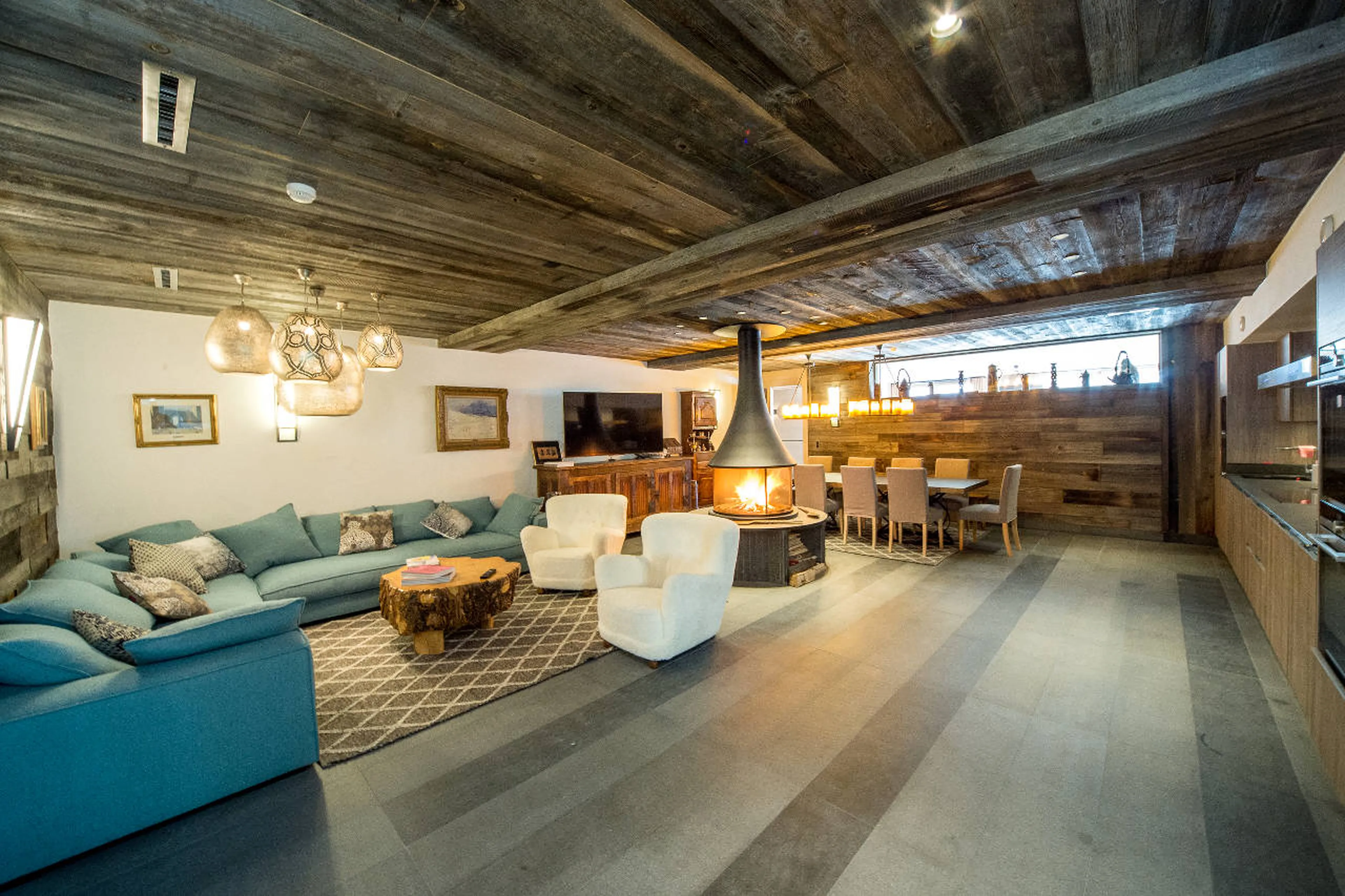 Lounge area, TV and dining area of entertainment room in Chalet Migui in Crans-Montana