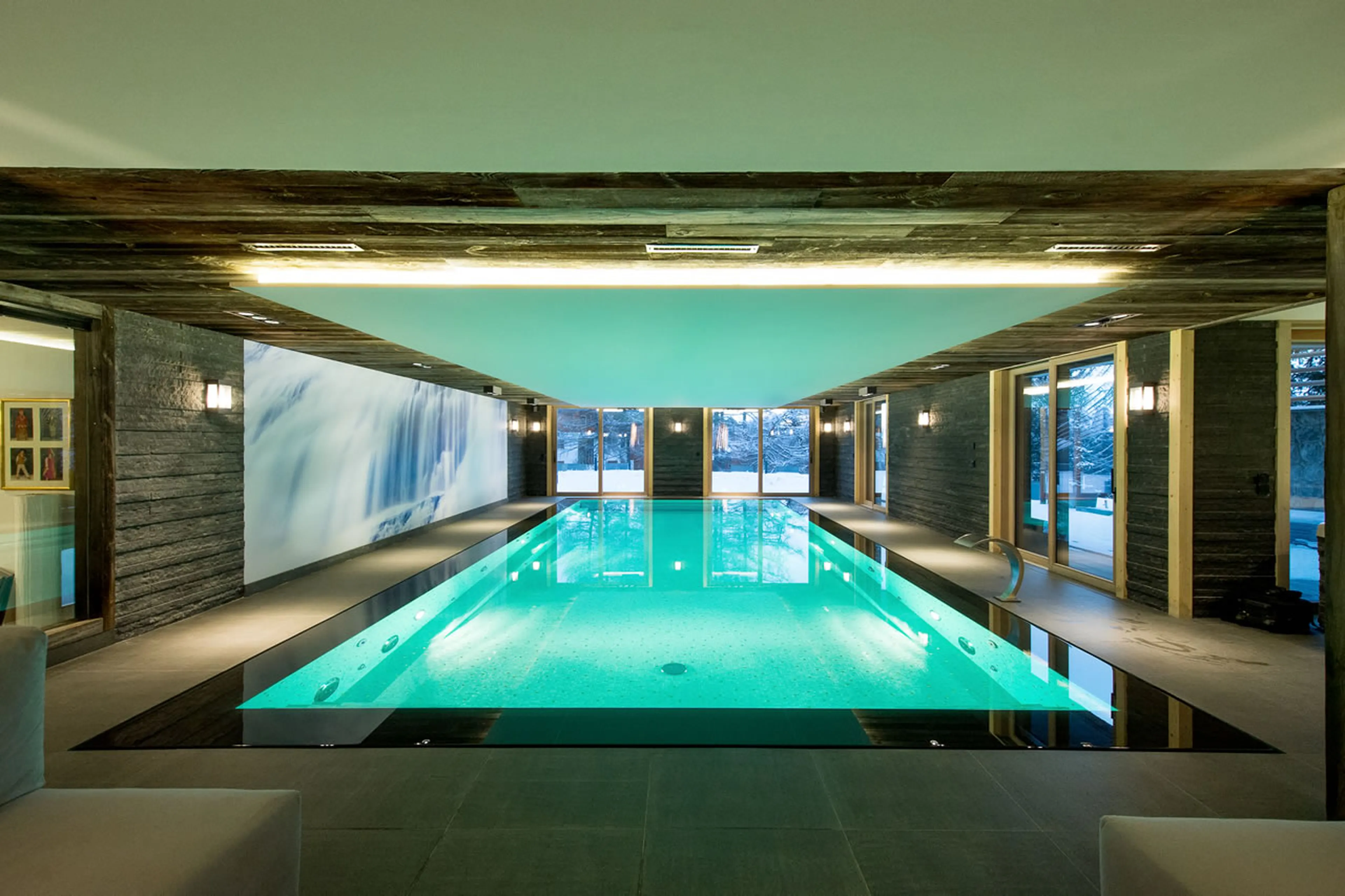 Indoor swimming pool with garden view in Chalet Migui in Crans-Montana