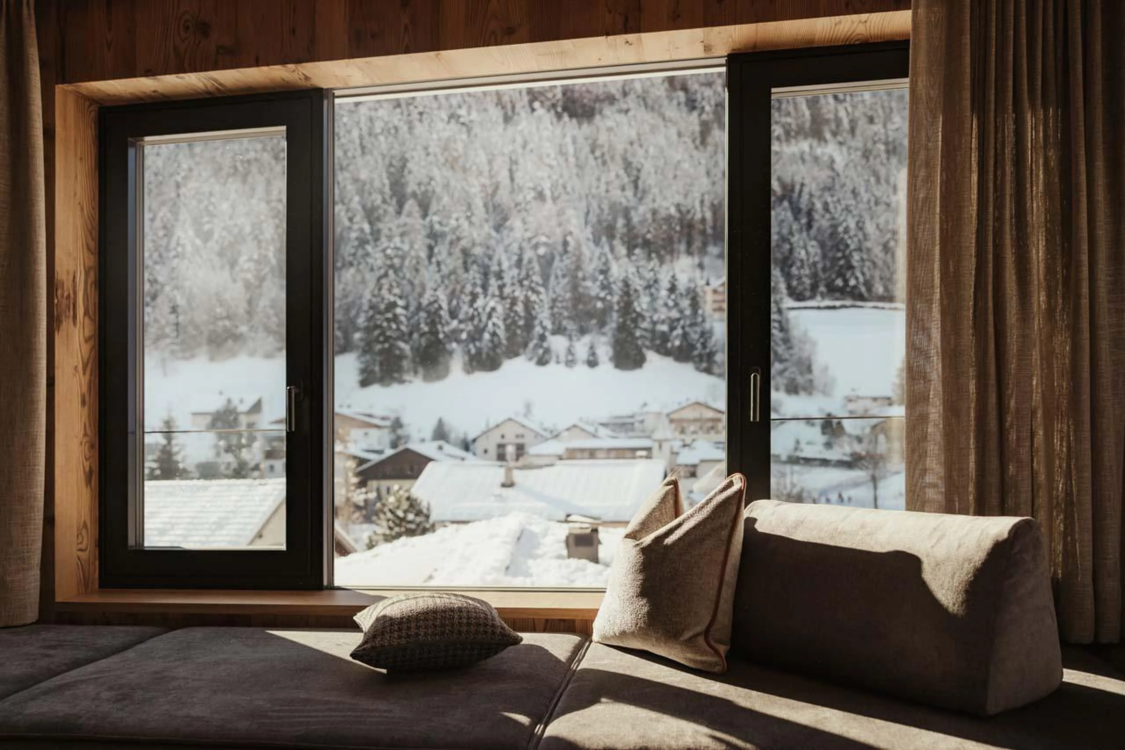 Snowy mountain views from open-plan living area at Chalet Mile 1 in Val Gardena