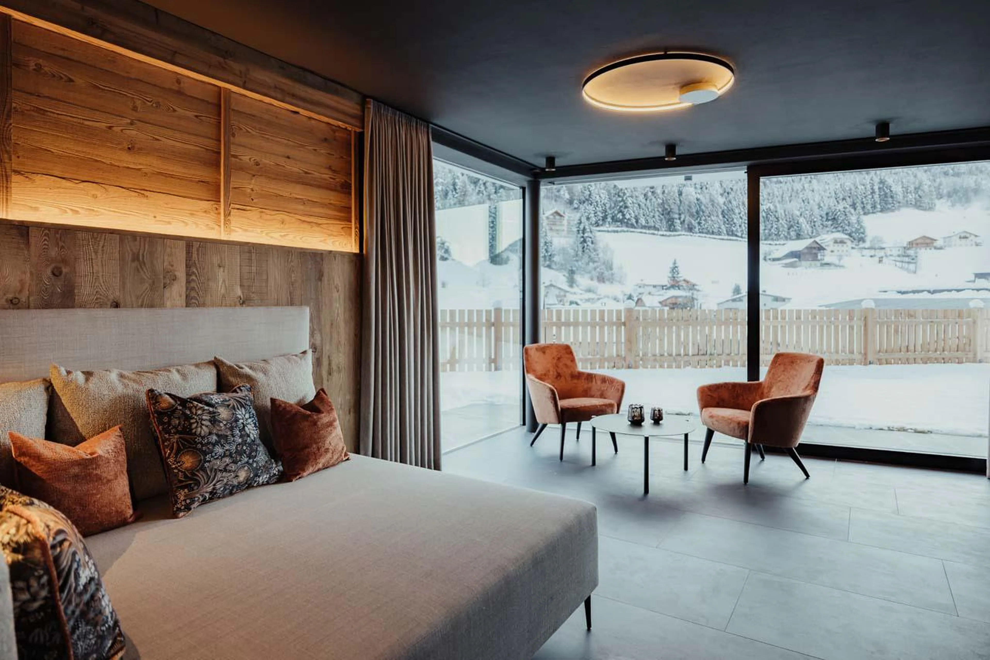 Private wellness area with sweeping floor-to-ceiling windows at Chalet Mile 2 in Val Gardena