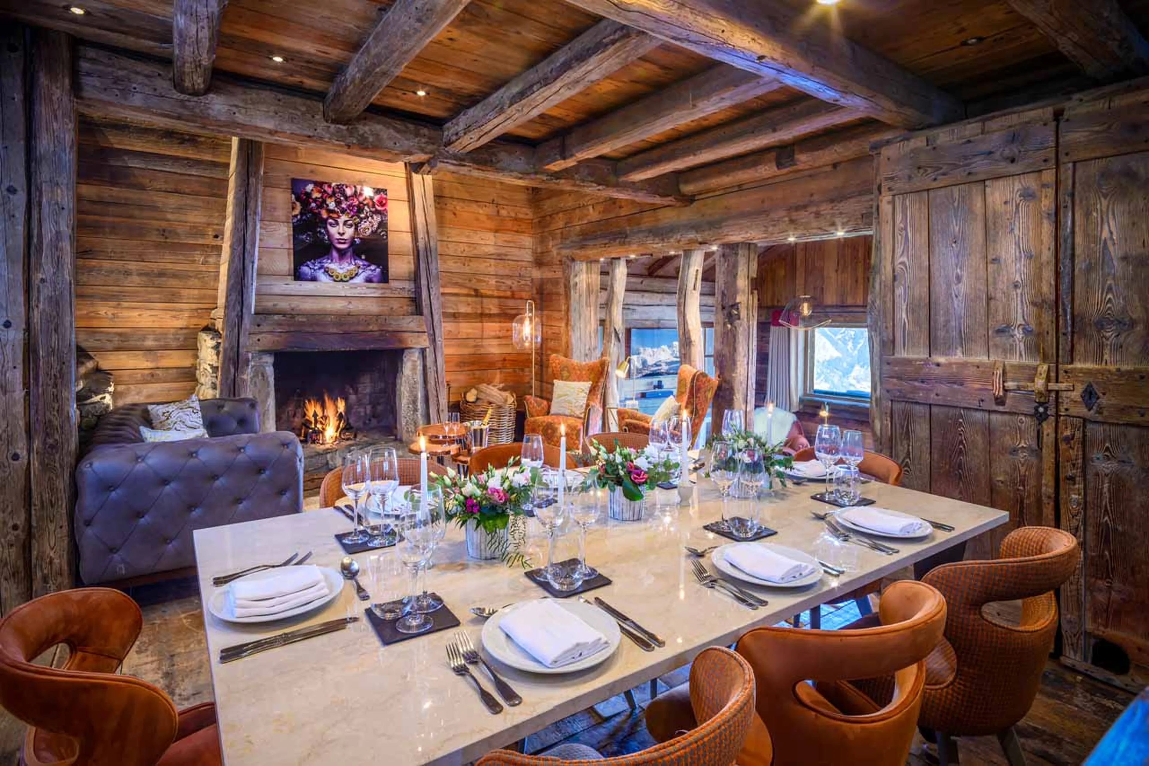 Dining table and living room at Chalet Montana in Courchevel 1850
