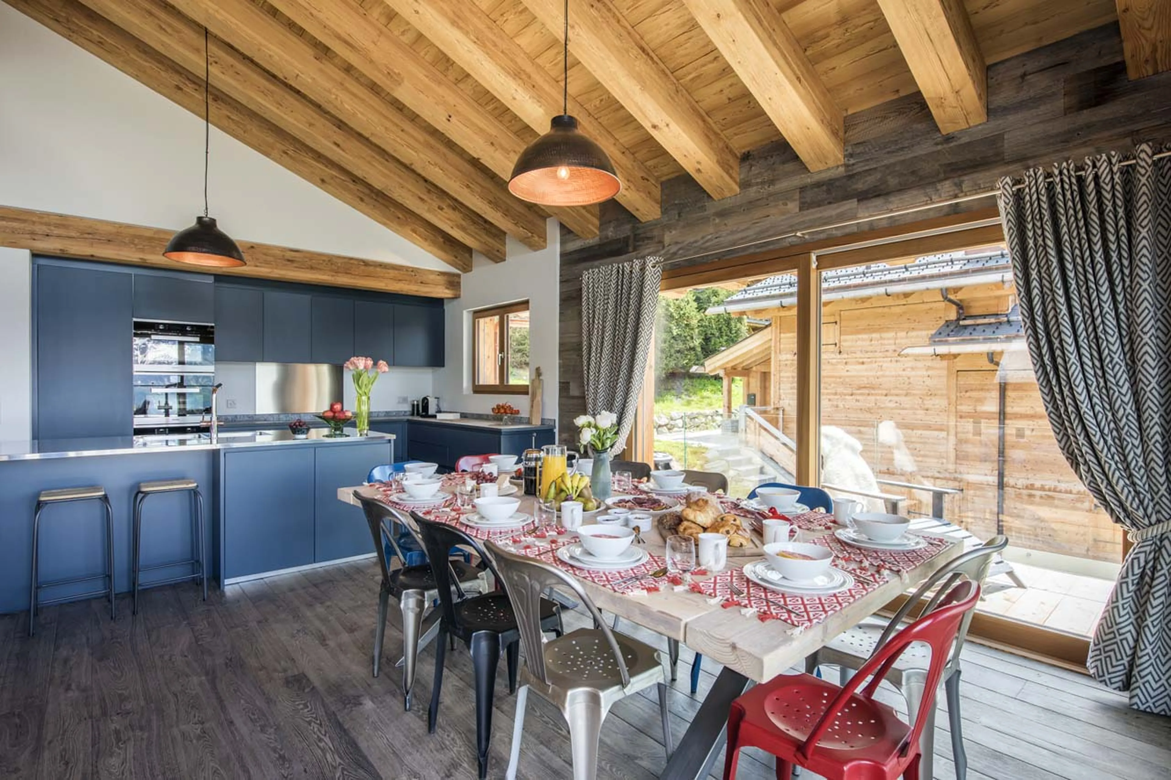 Dining table and kitchen at  Chalet Mowgli in Verbier