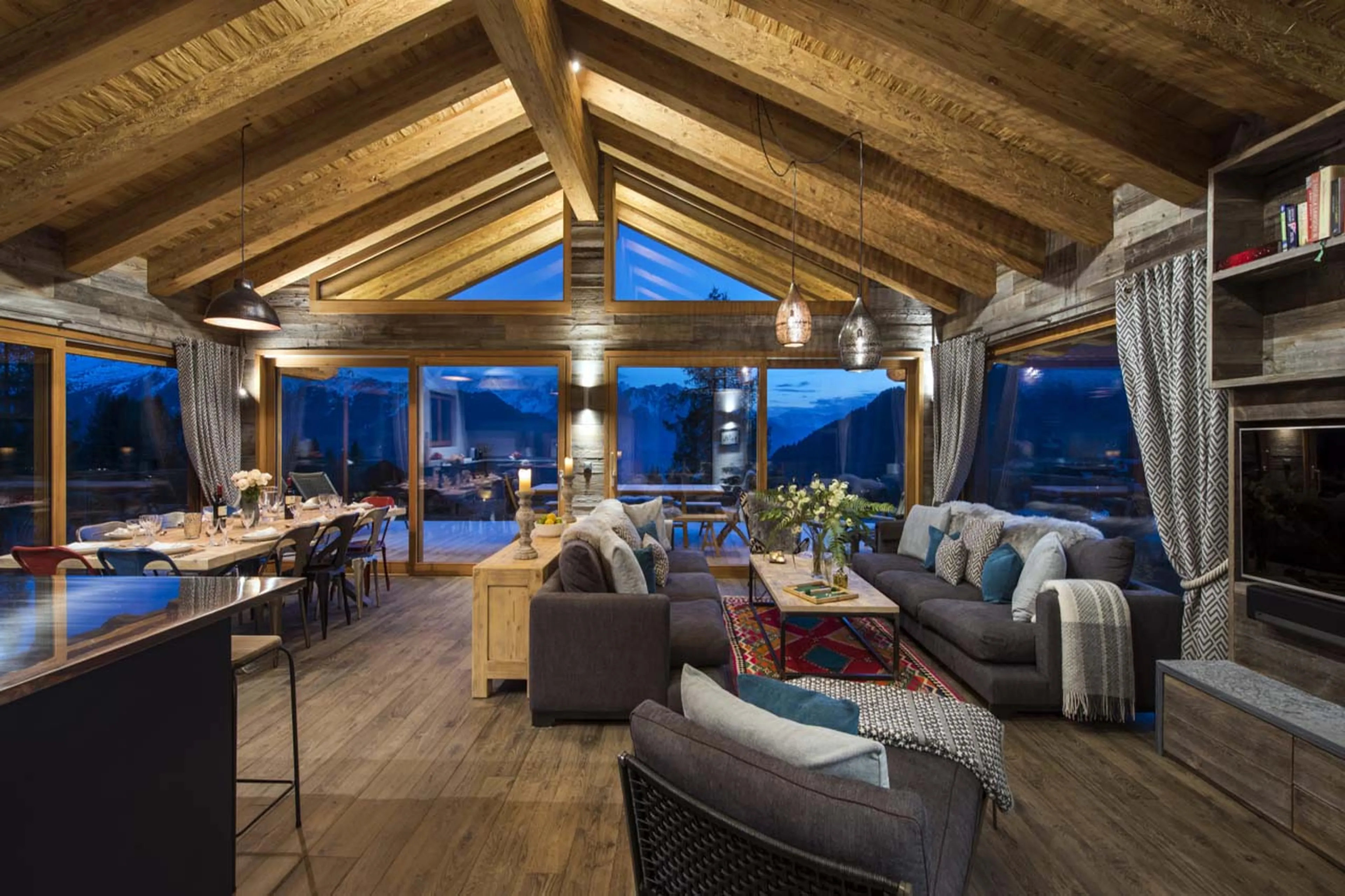 Open plan living area at night in Chalet Mowgli in Verbier