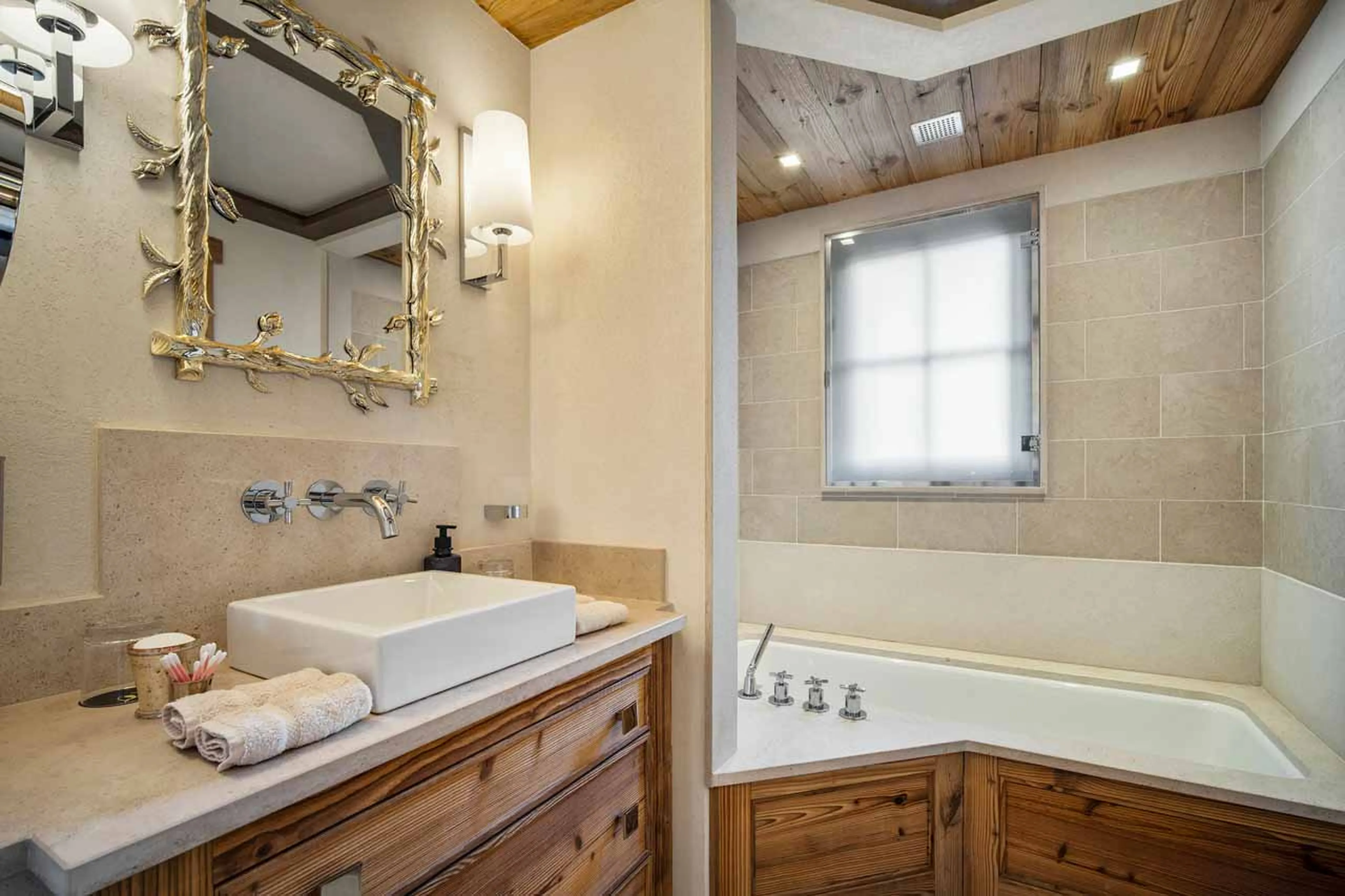 En suite bathroom with bath, shower and single basin in Chalet Nanuq in Courchevel 1850