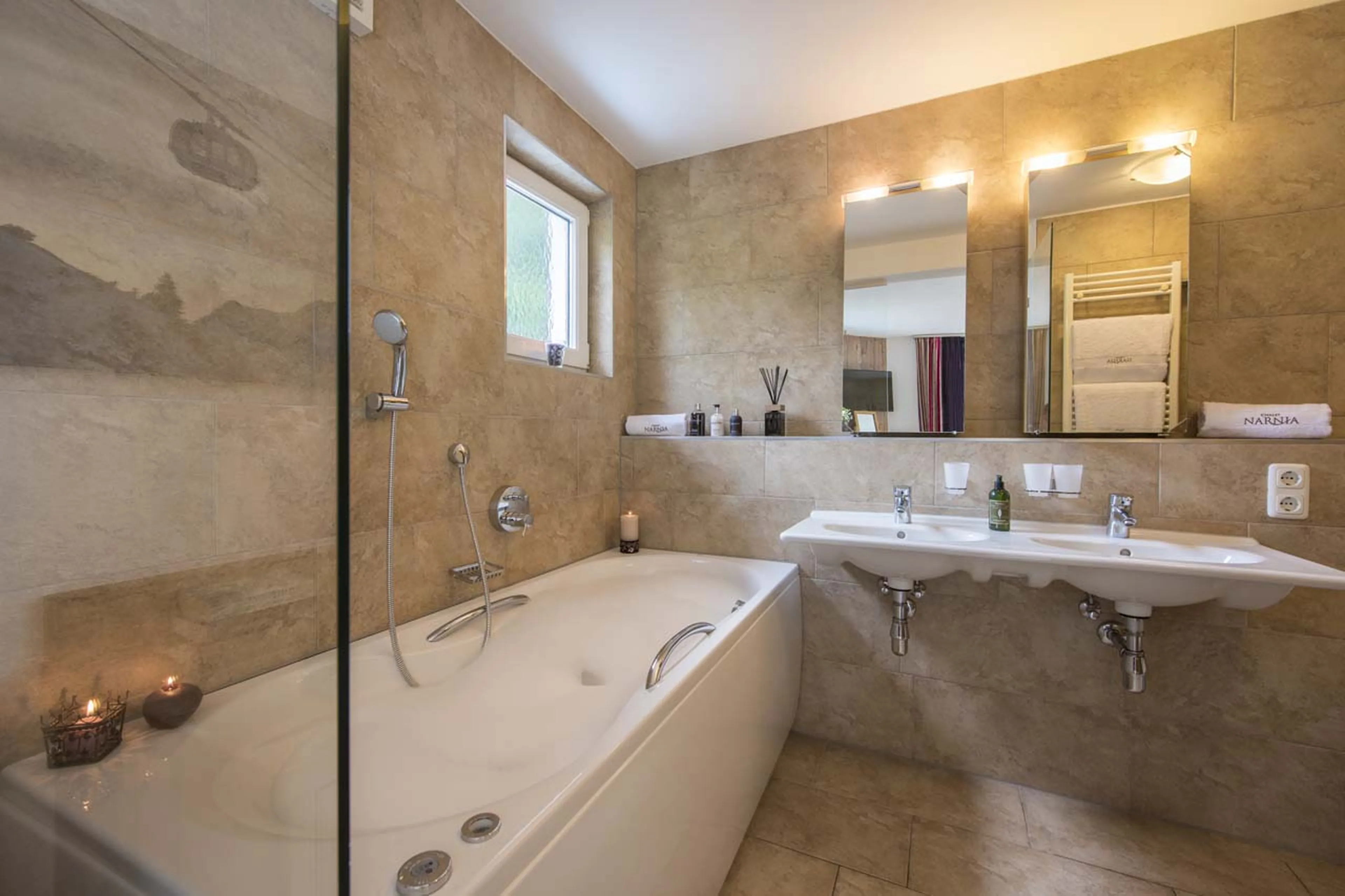 Bath tub in bathroom three at Chalet Narnia in St Anton