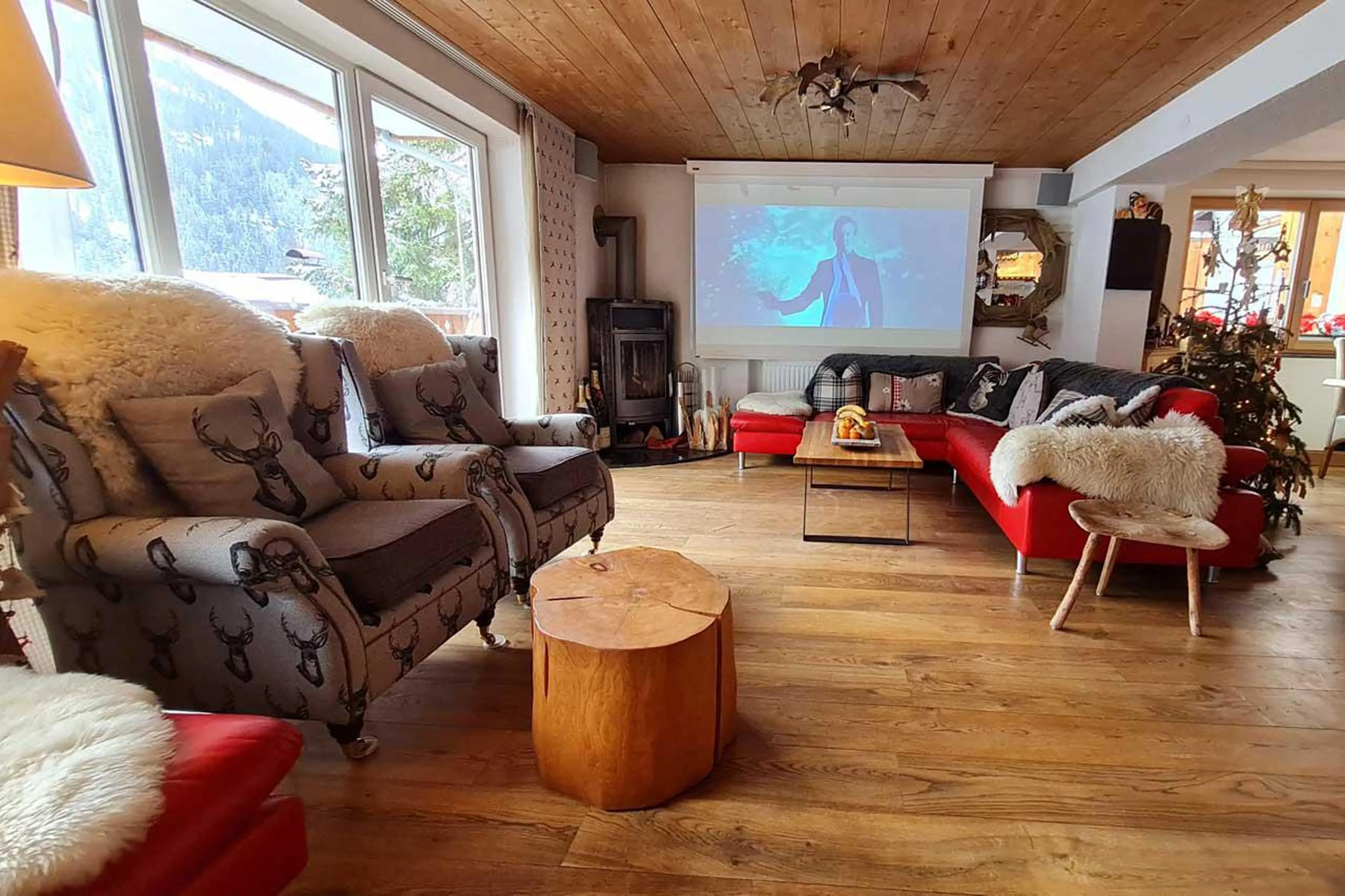 Open-plan living space with wood-burning fireplace at Chalet Narnia in St Anton