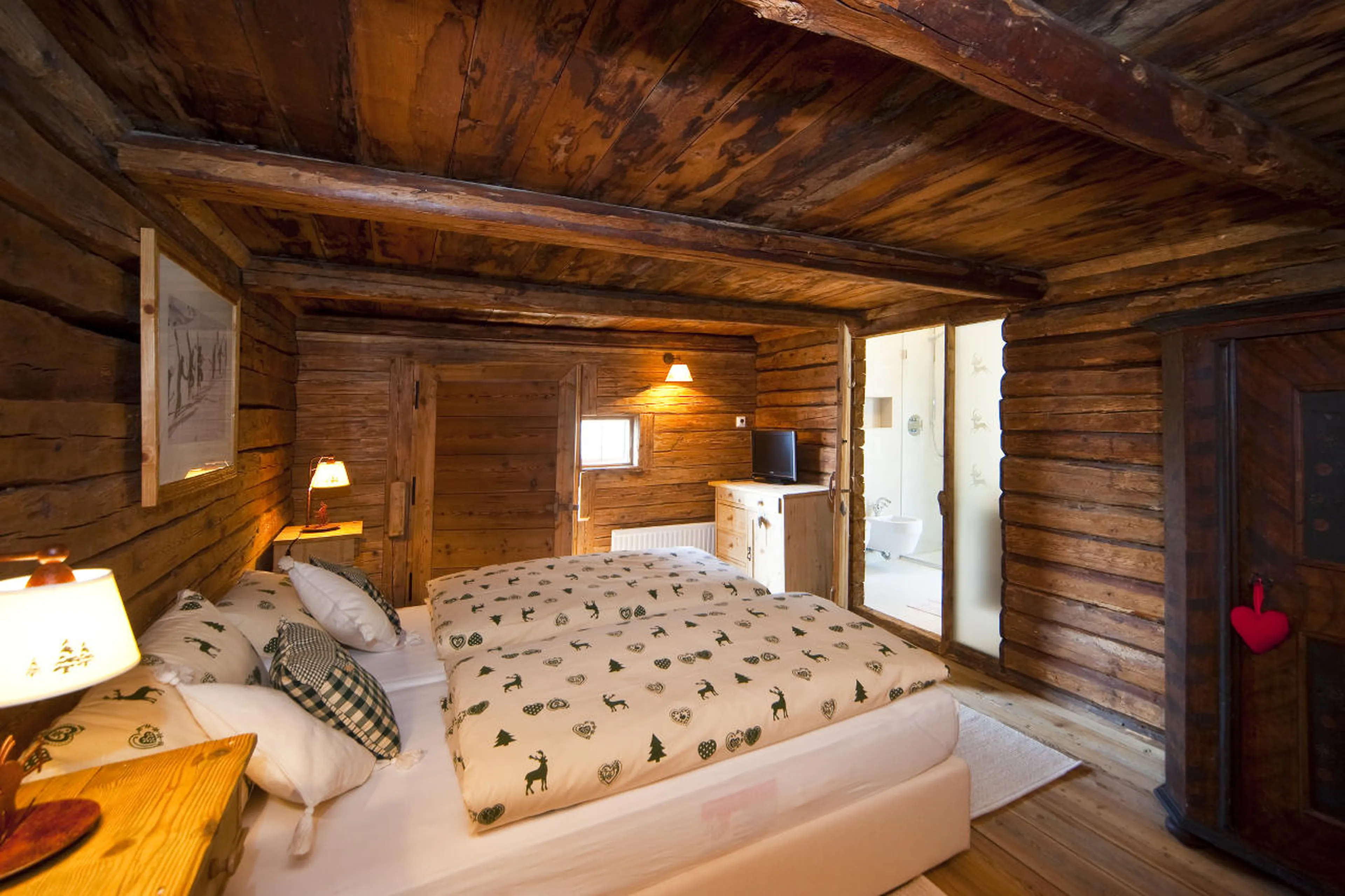 Double bedroom with balcony access in Chalet Obertreyen near Kronplatz