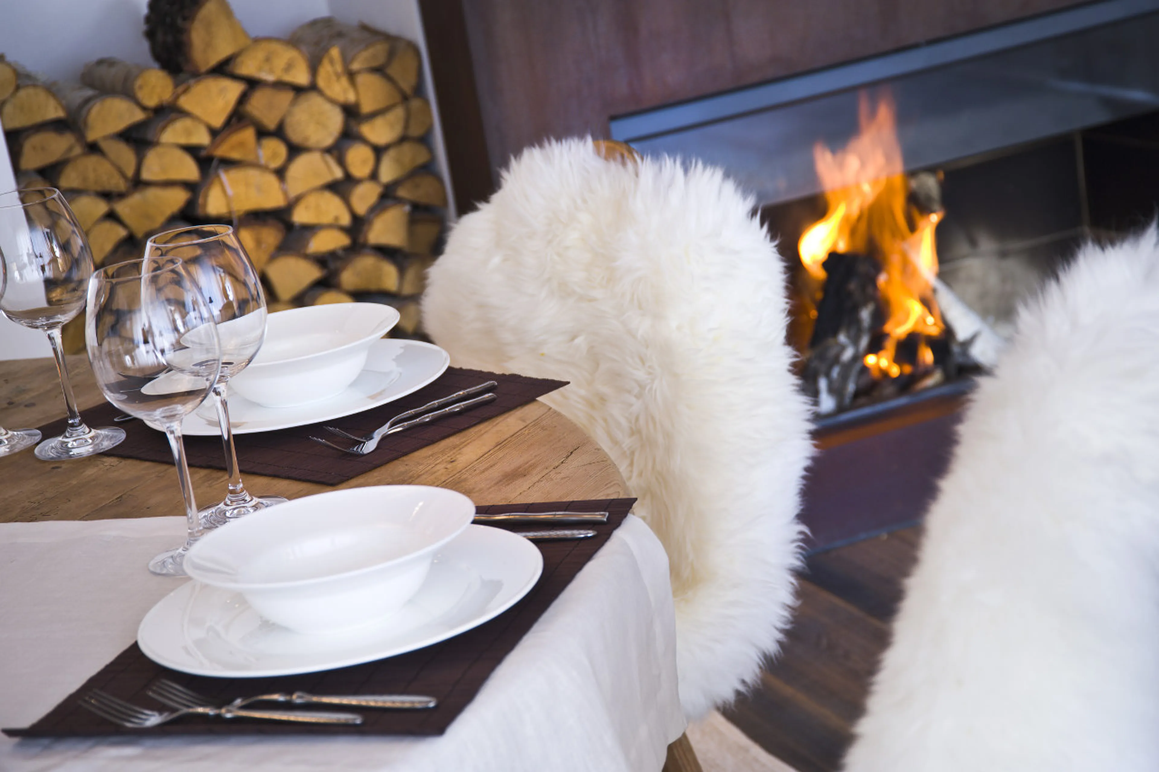 Log fireplace in living area of Chalet Obertreyen near Kronplatz