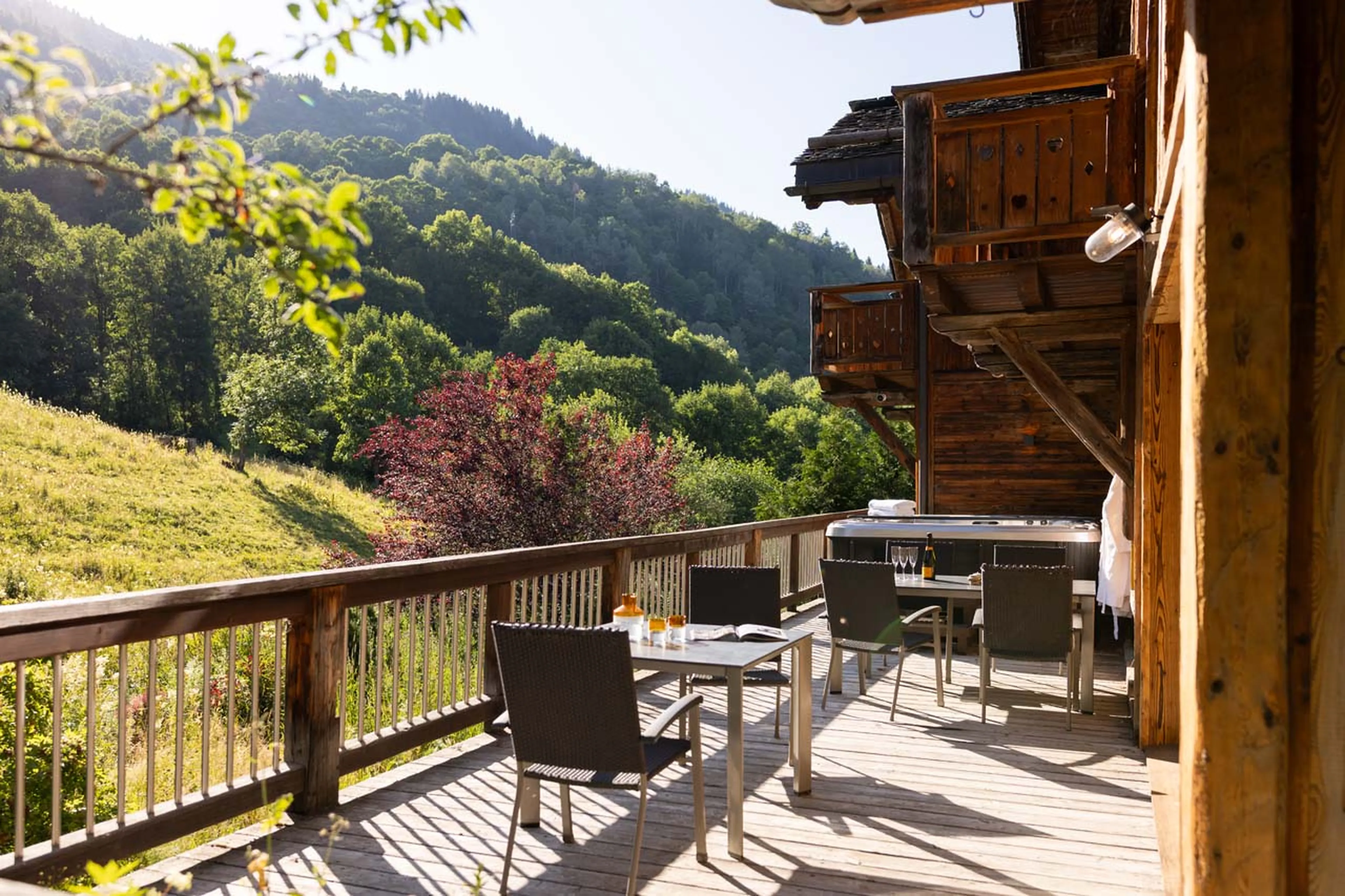Balcony with hot tub and dining table at Chalet L'Orchidée in Meribel