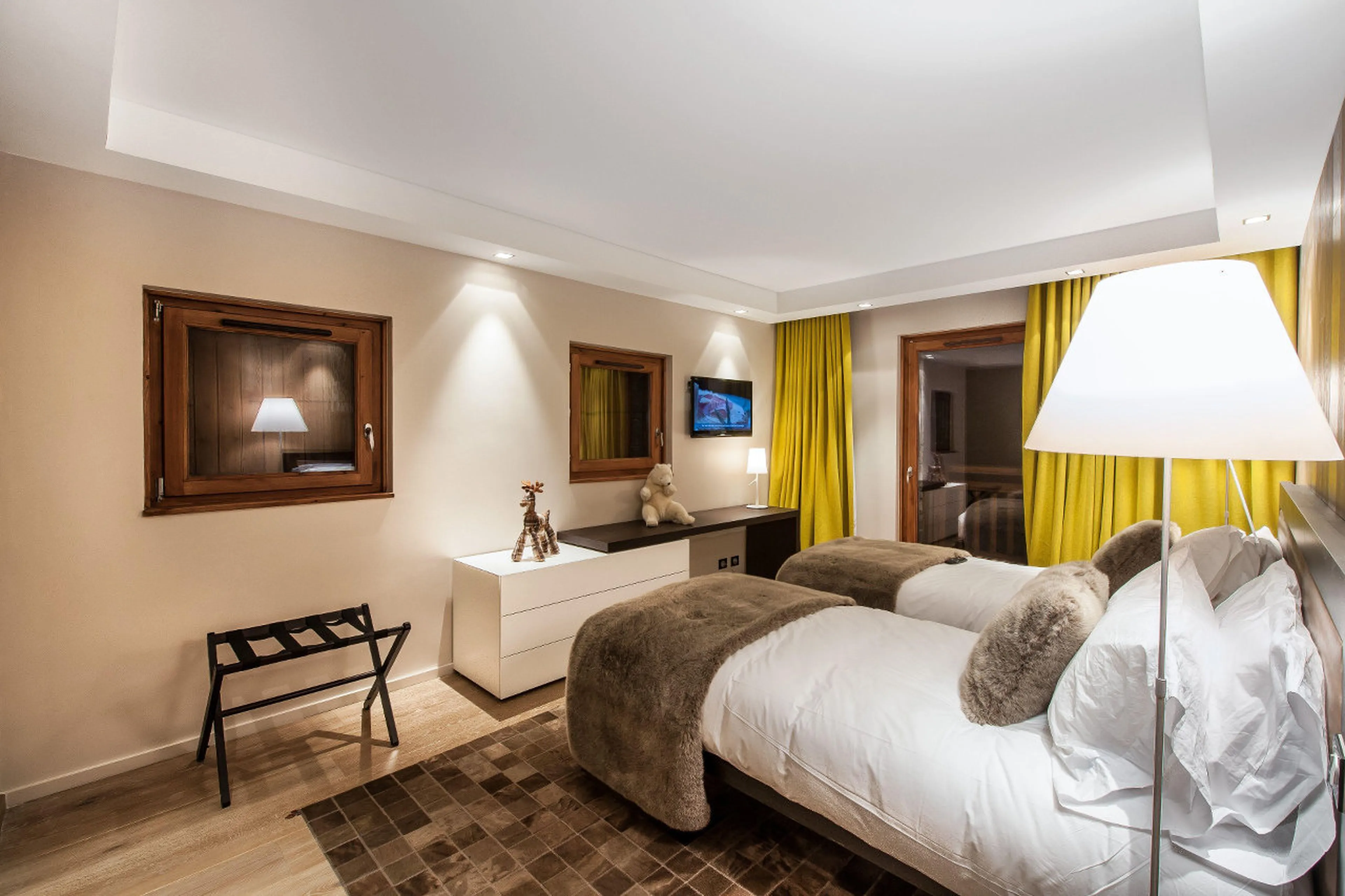 Bedroom with twin beds and balcony access in Chalet Overview in Courchevel 1650
