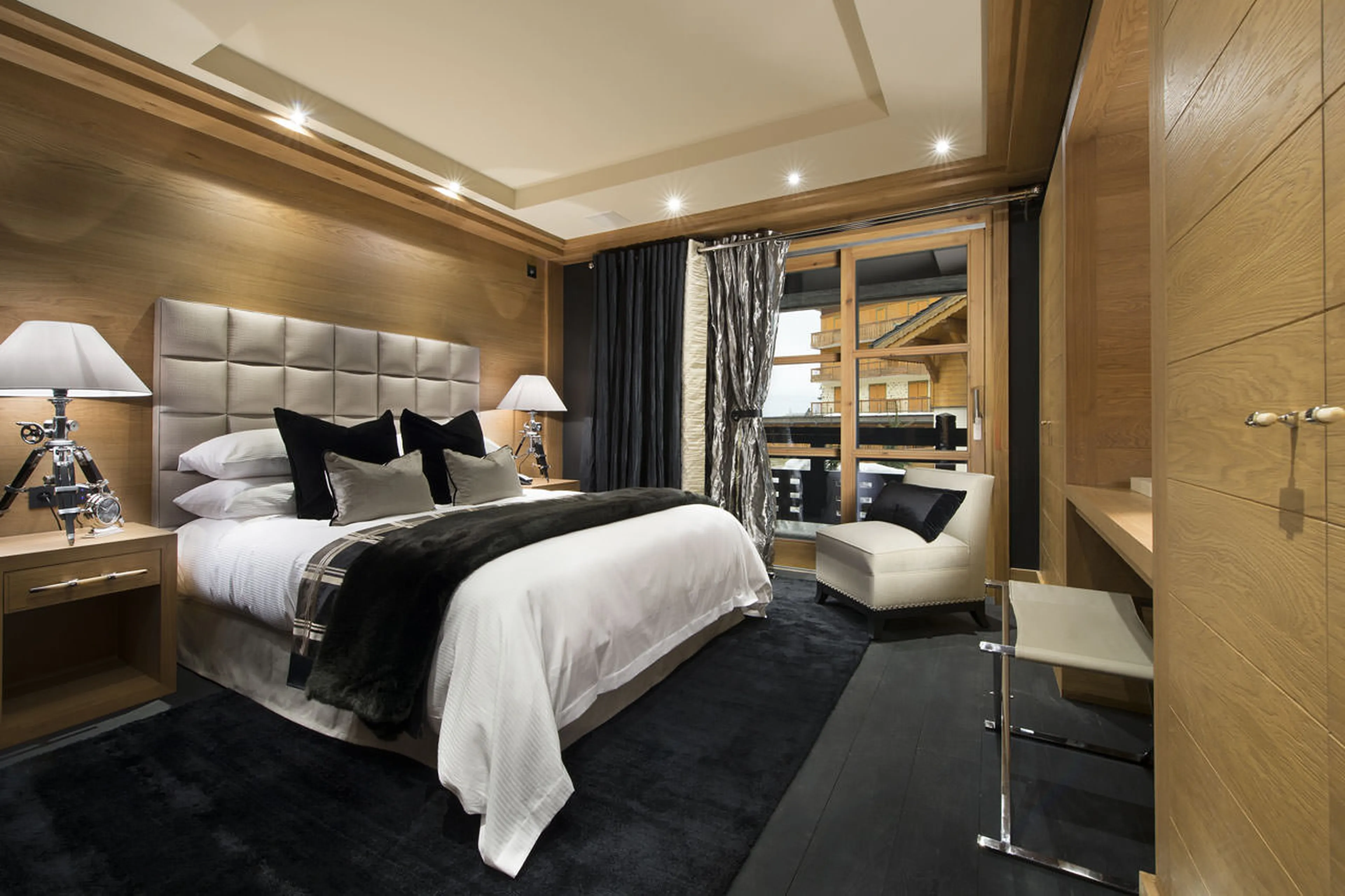 Bedroom with king-size bed and balcony access in chalet Le Petit Palais in Courchevel 1850