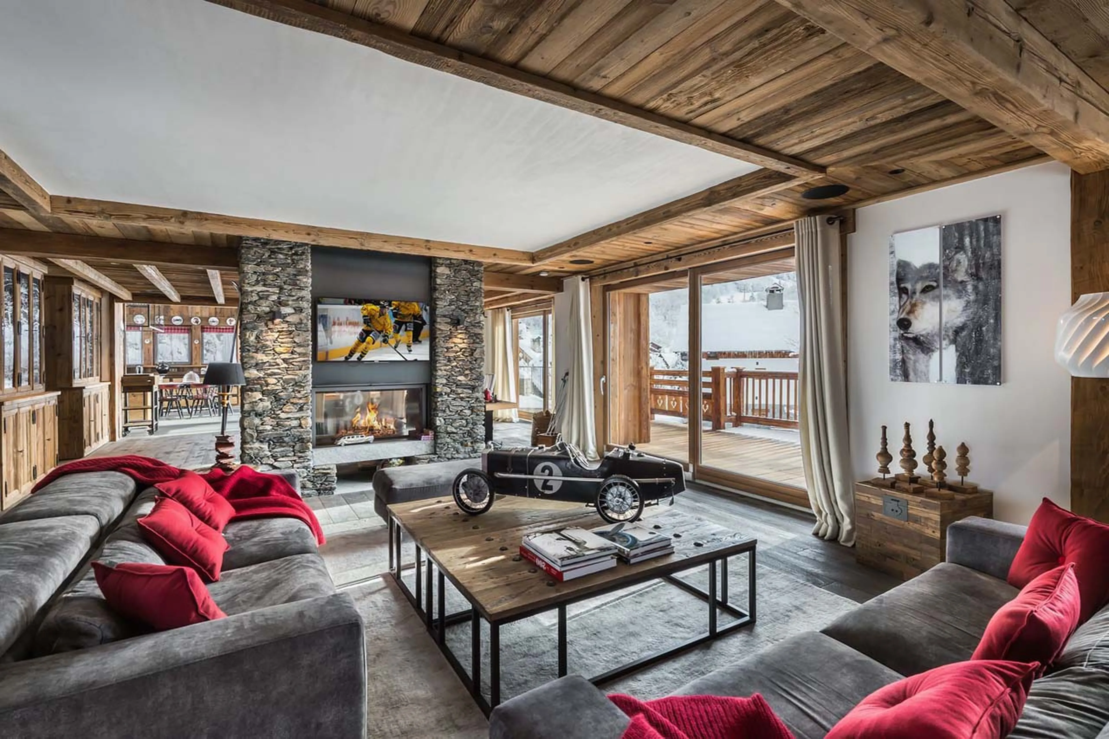 Fireplace and sofas in living room at Chalet Queen Mijane in Meribel