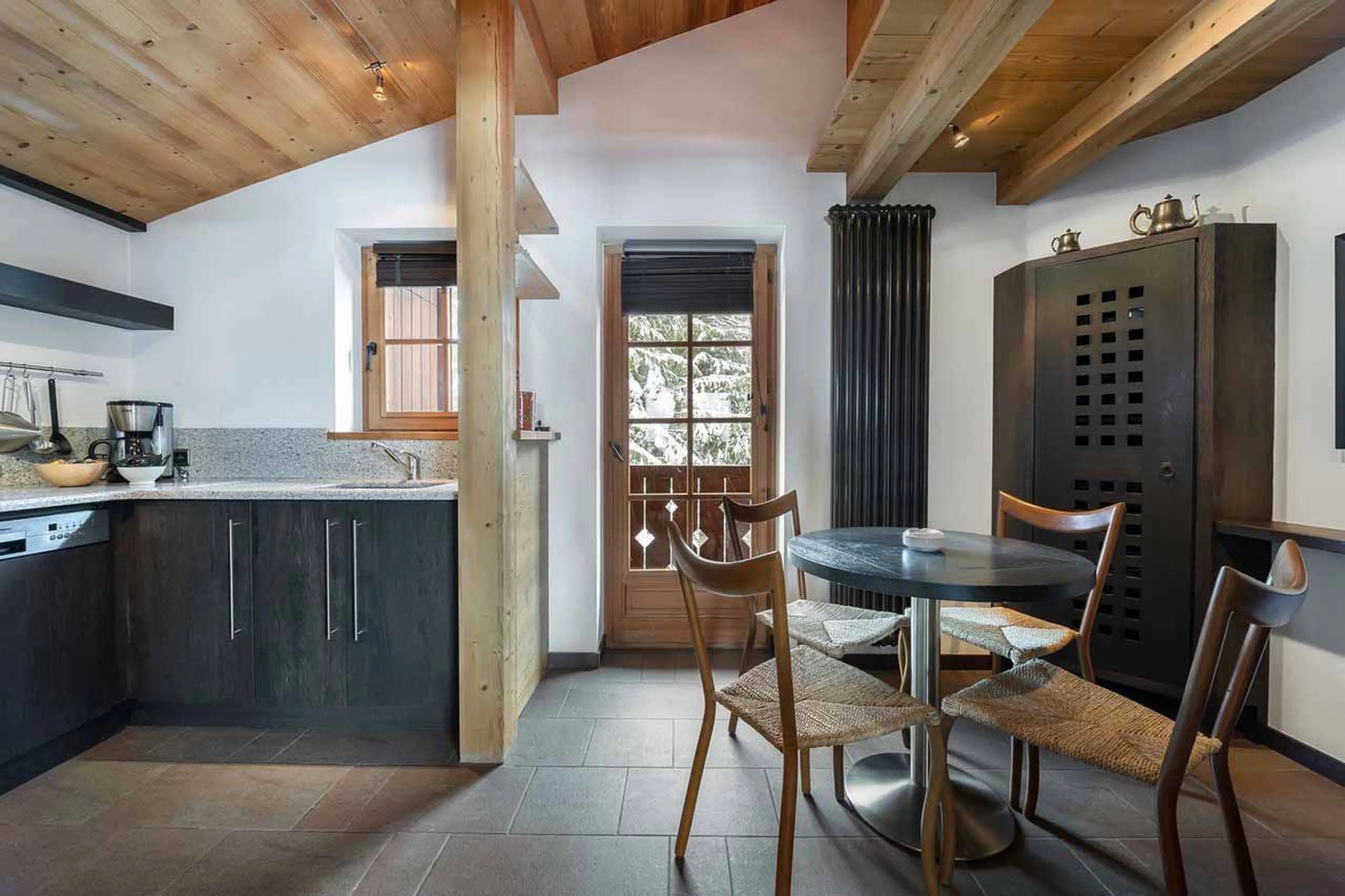 Kitchen opening onto balcony at Chalet Reine des Pres in Megeve