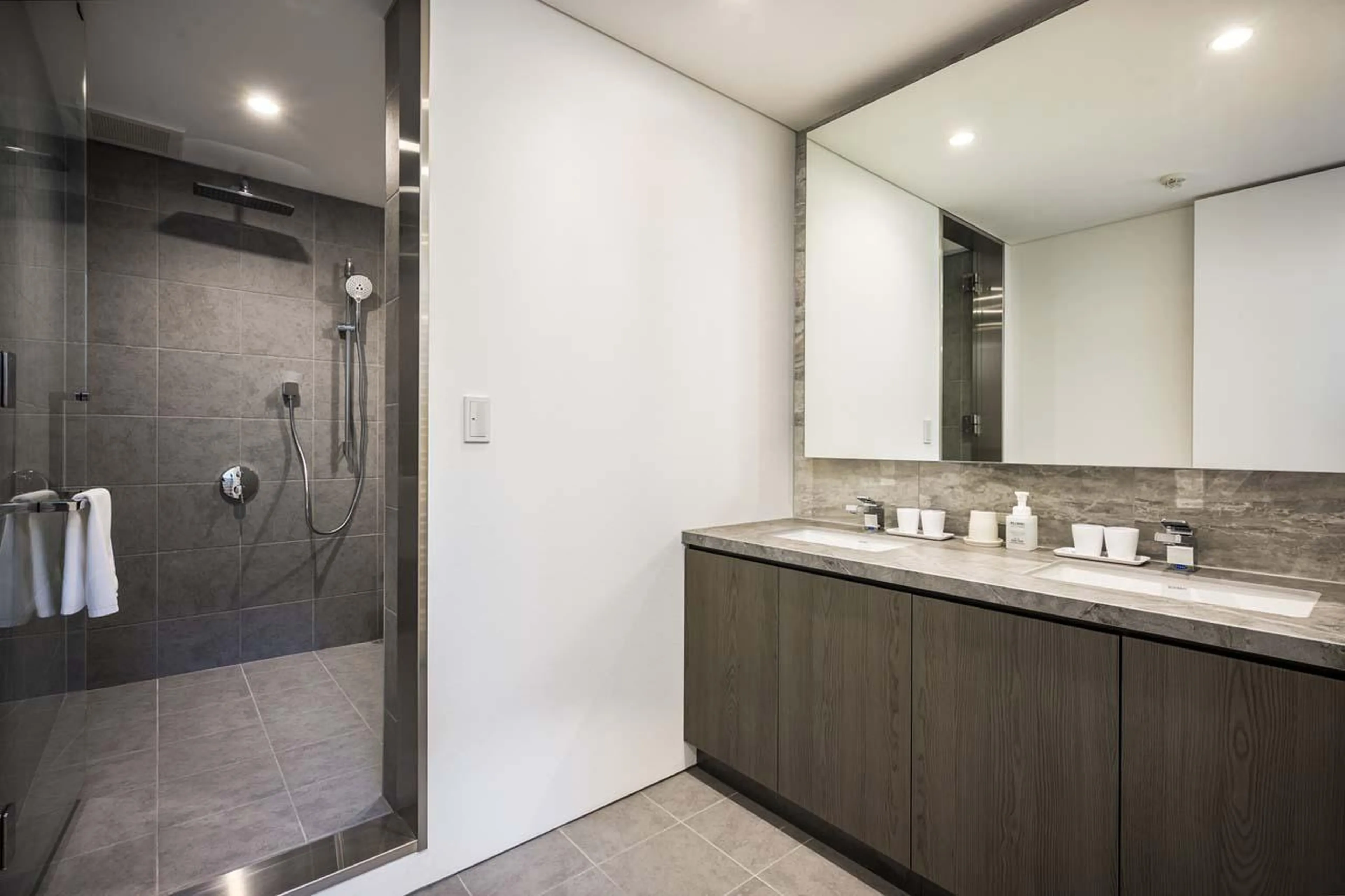 Bathroom with bath, shower and double basin at Chalet Ryoun in Niseko