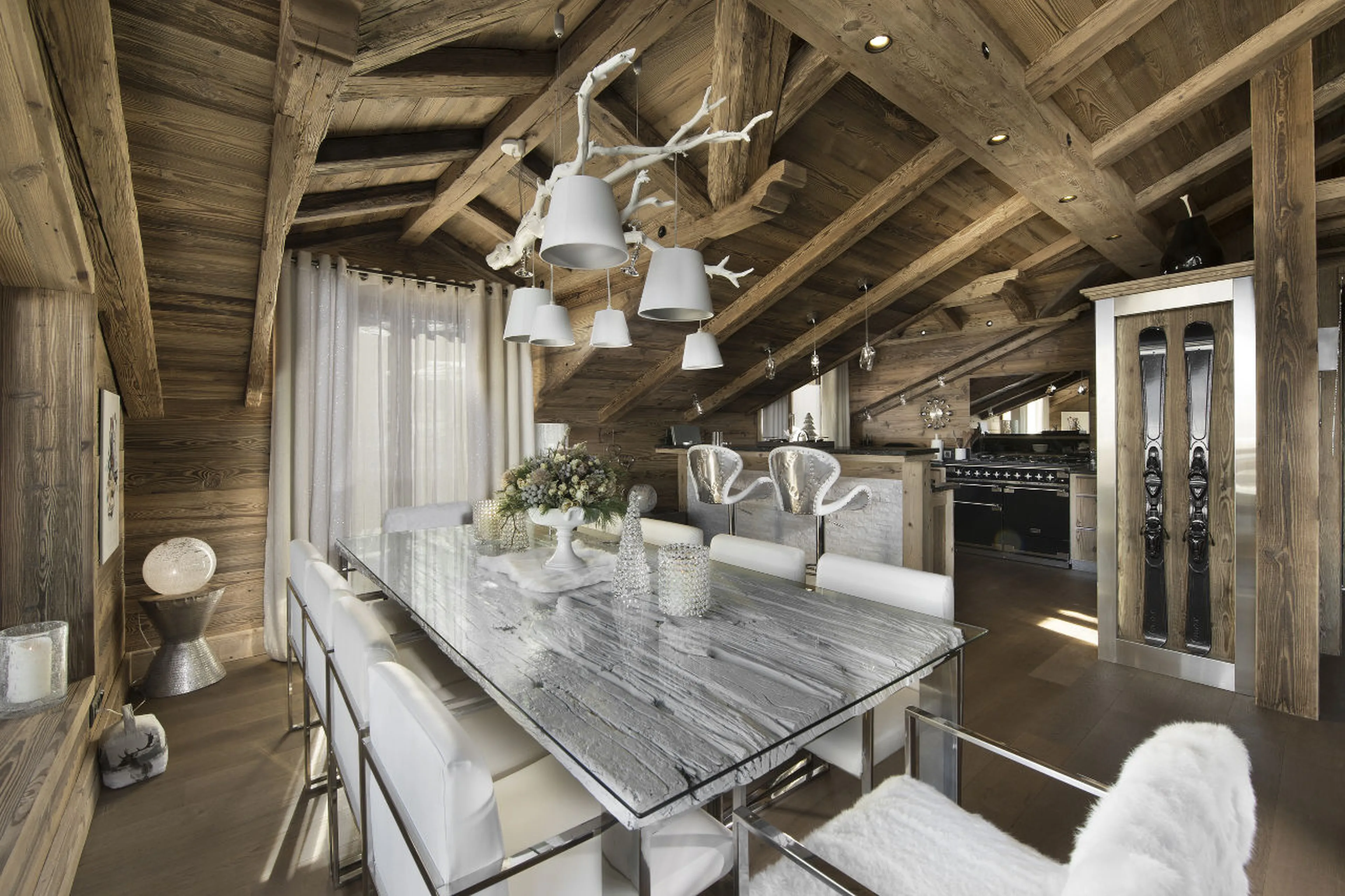 Dining table and modern kitchen at Chalet S in Courchevel 1550