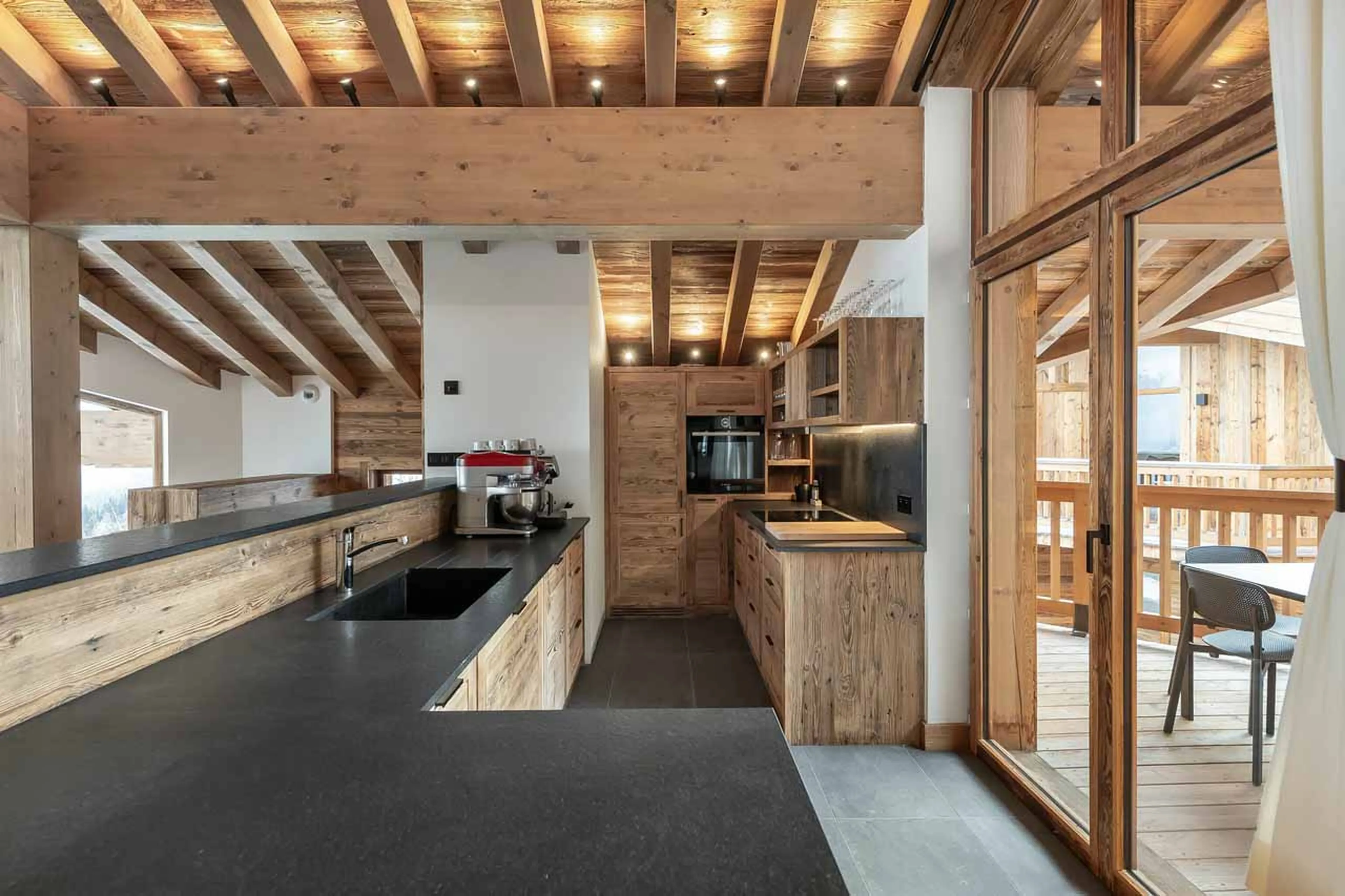 Kitchen and terrace at Chalet San Pietro in Courchevel 1850