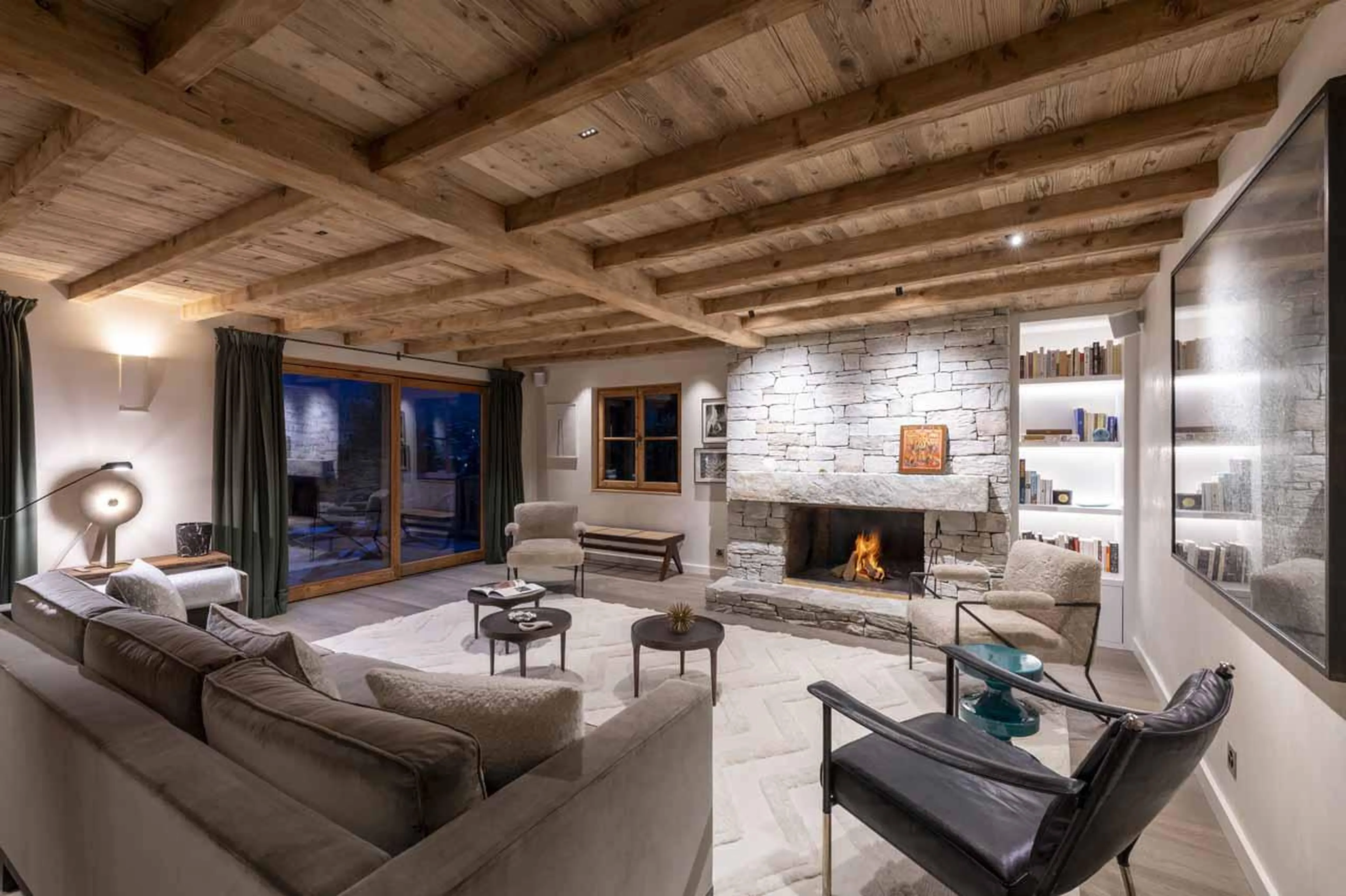 Open-plan living area with fireplace at Chalet Scandinavia, Verbier, Switzerland