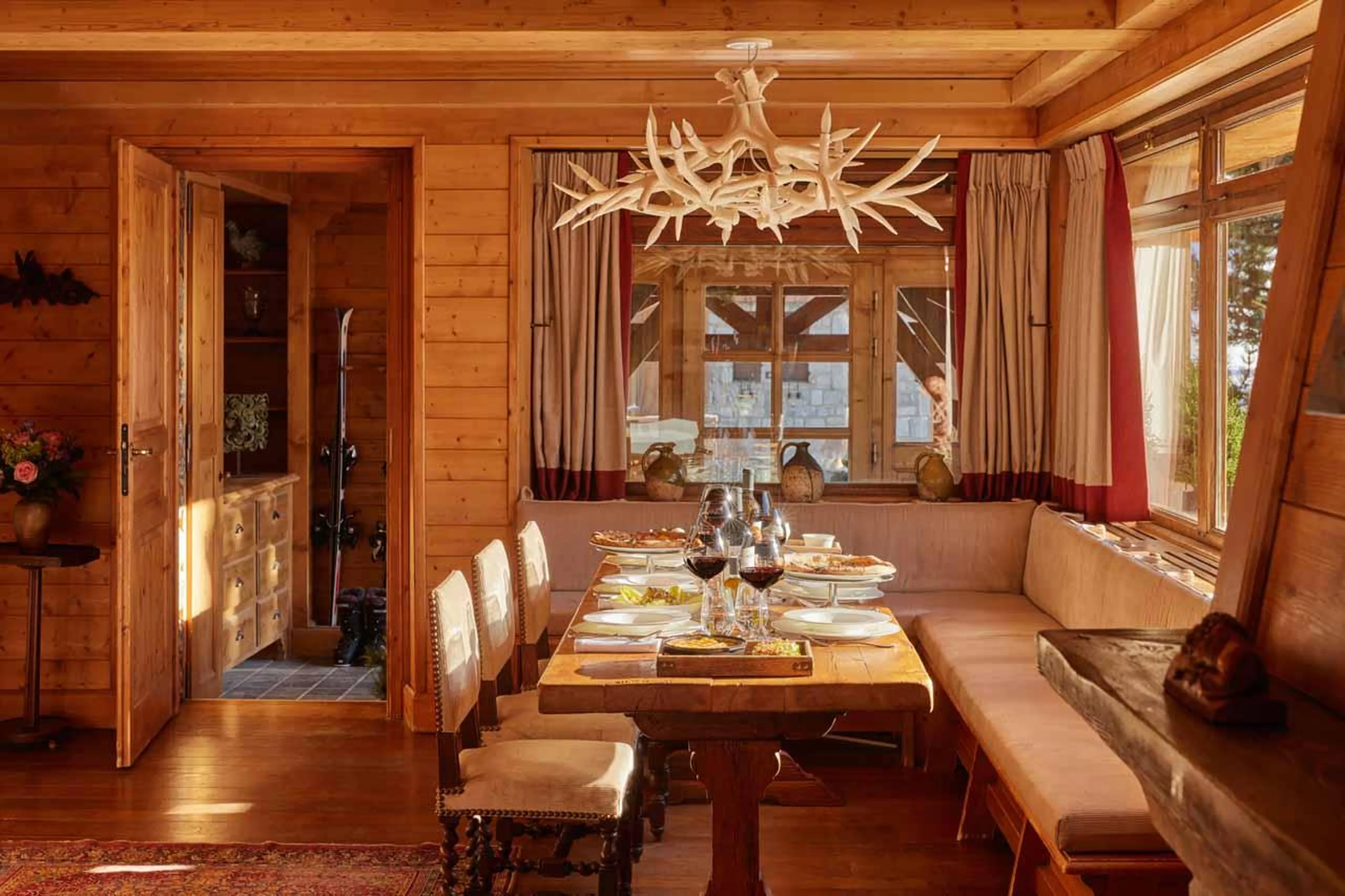 Dining table with bench seating on one side in Chalet Schuss, Val d'Isere