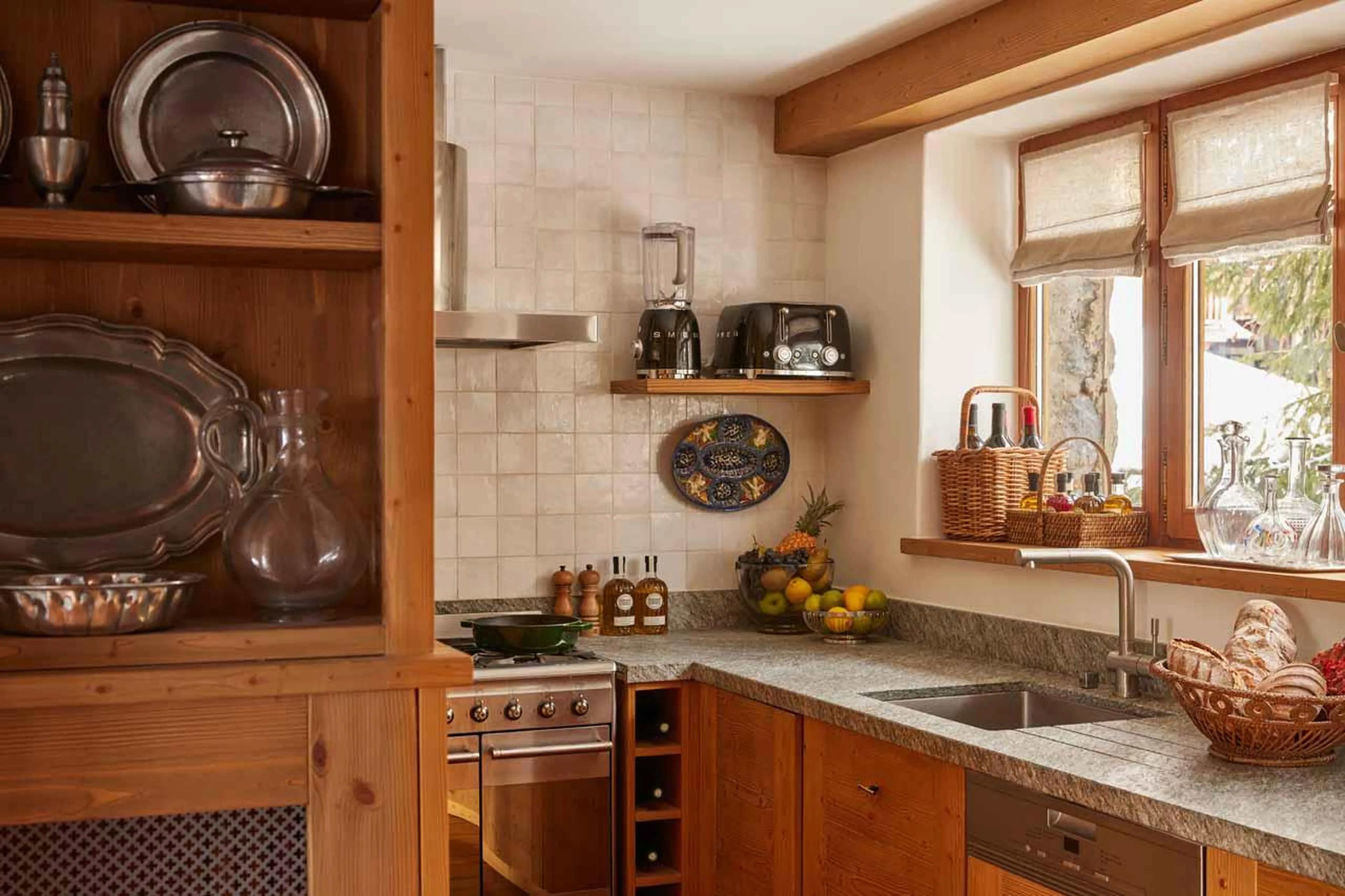 Kitchen with wooden facade and modern appliances in Chalet Schuss, Val d'Isere