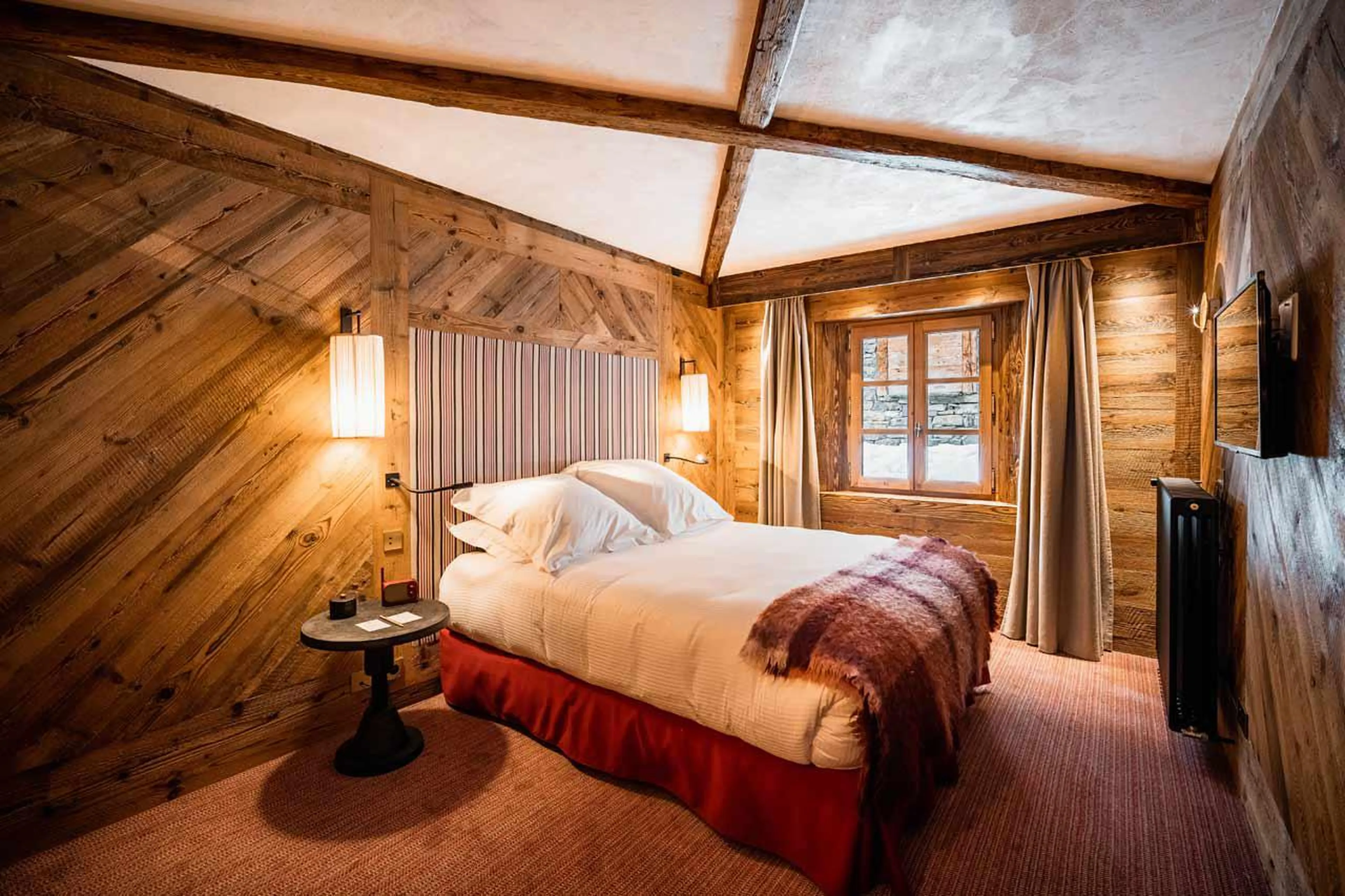 En suite double bedroom with soft carpets and panelled walls in Chalet Sequoia in Val d’ Isere