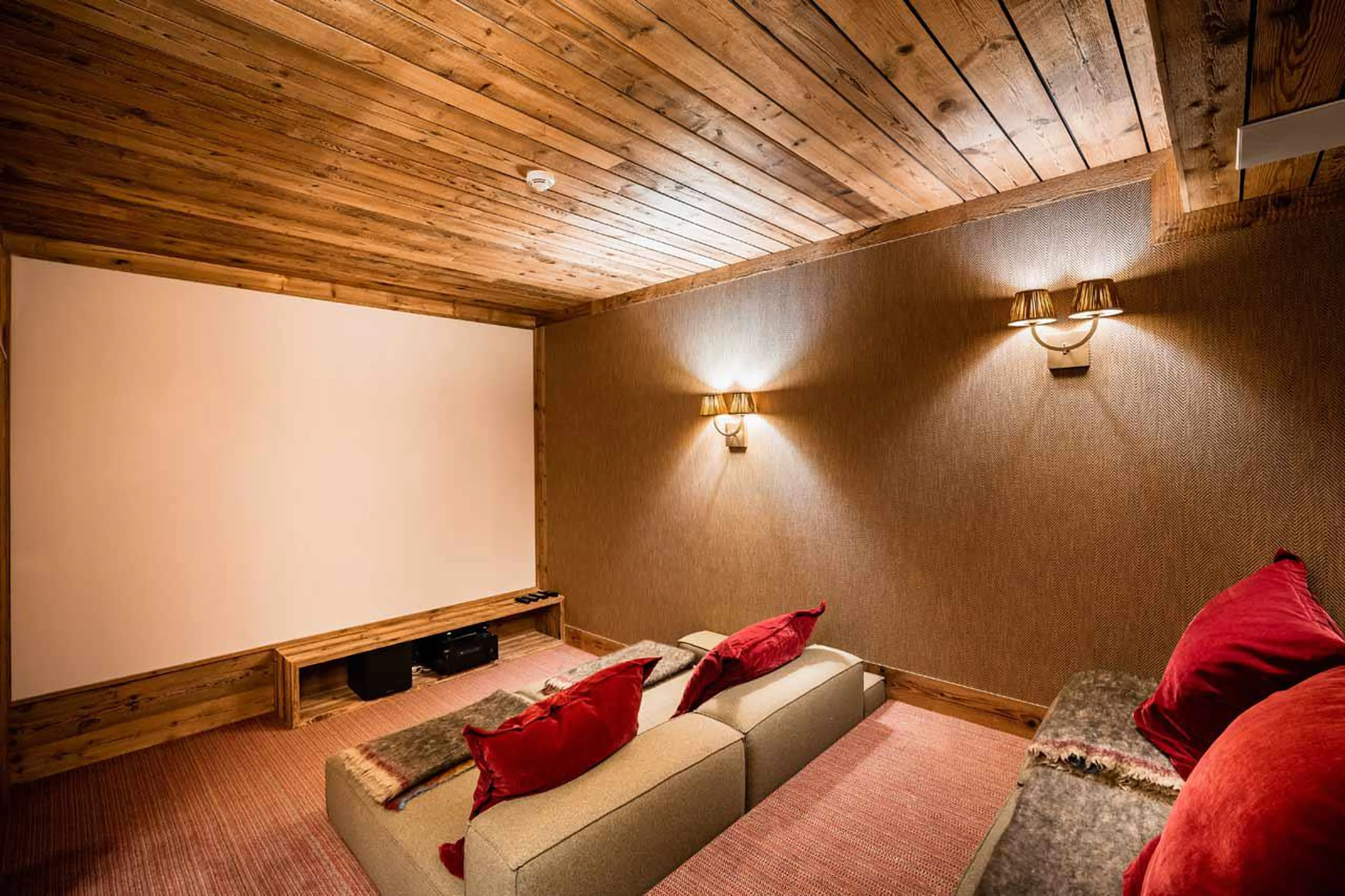 Home cinema with soft lights and comfortable couches in Chalet Sequoia in Val d’ Isere