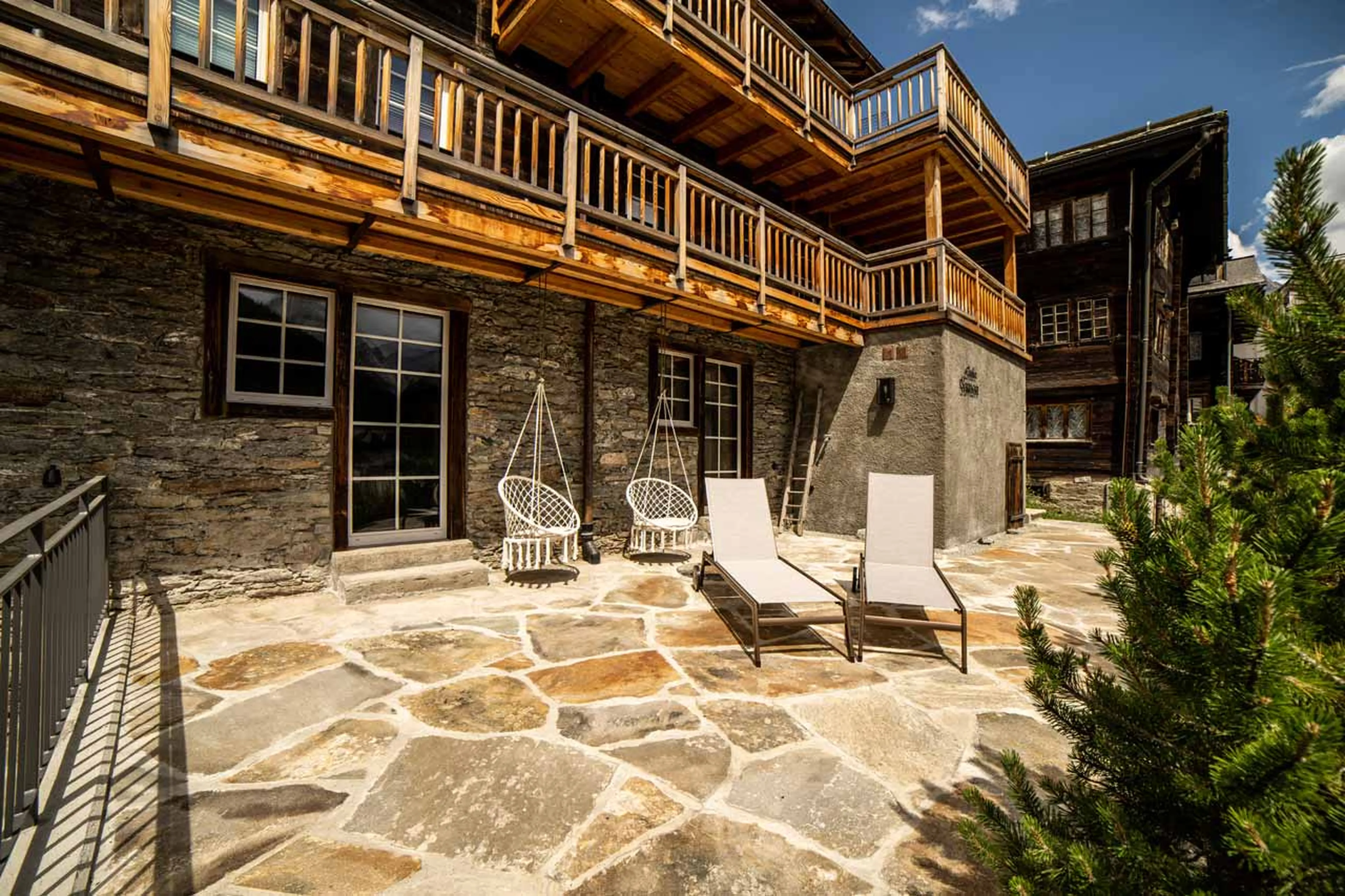 Terrace with sun loungers at Chalet Simon in Saas Fee