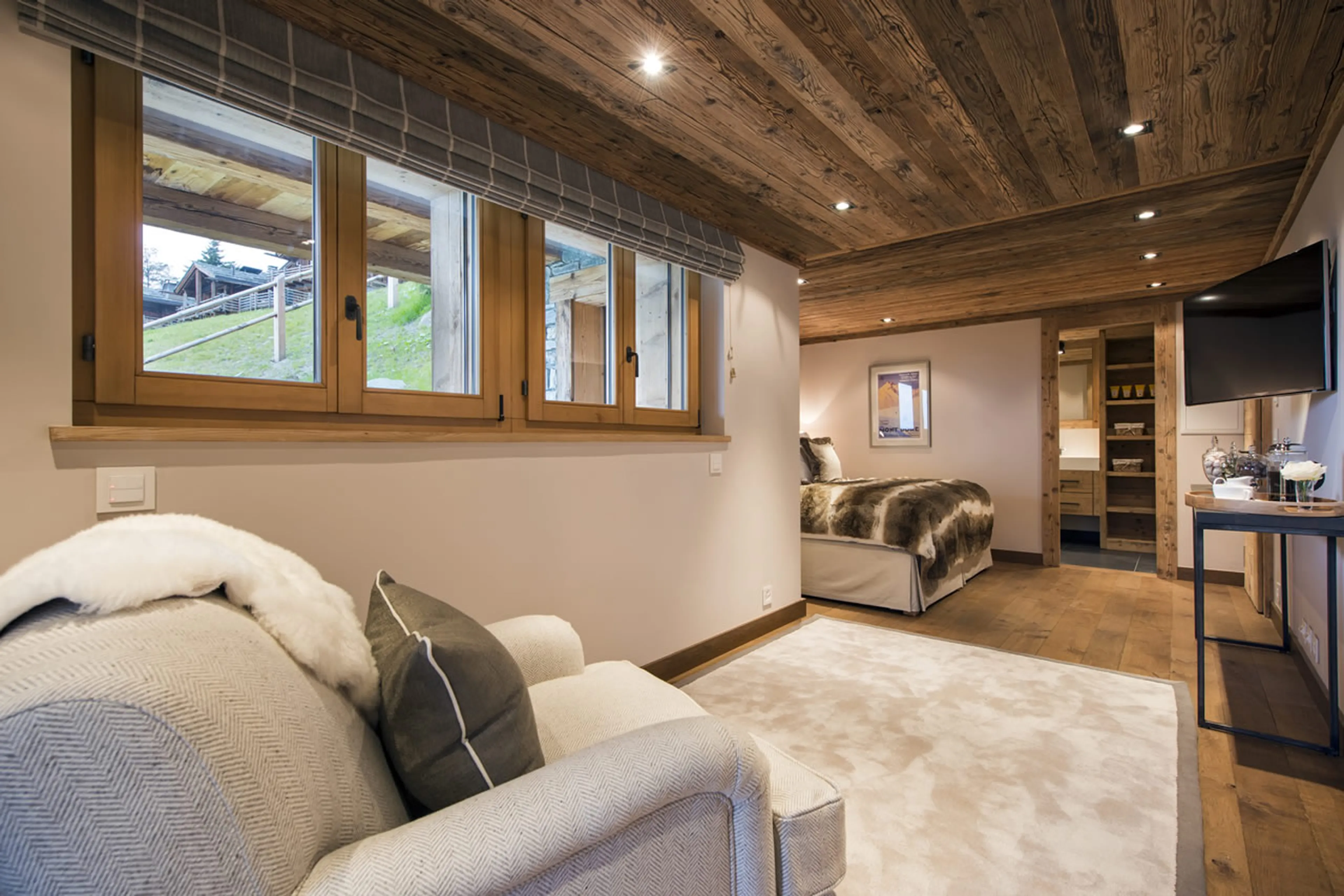 TV and armchair in twin/double bedroom on first floor at Chalet Sirocco in Verbier