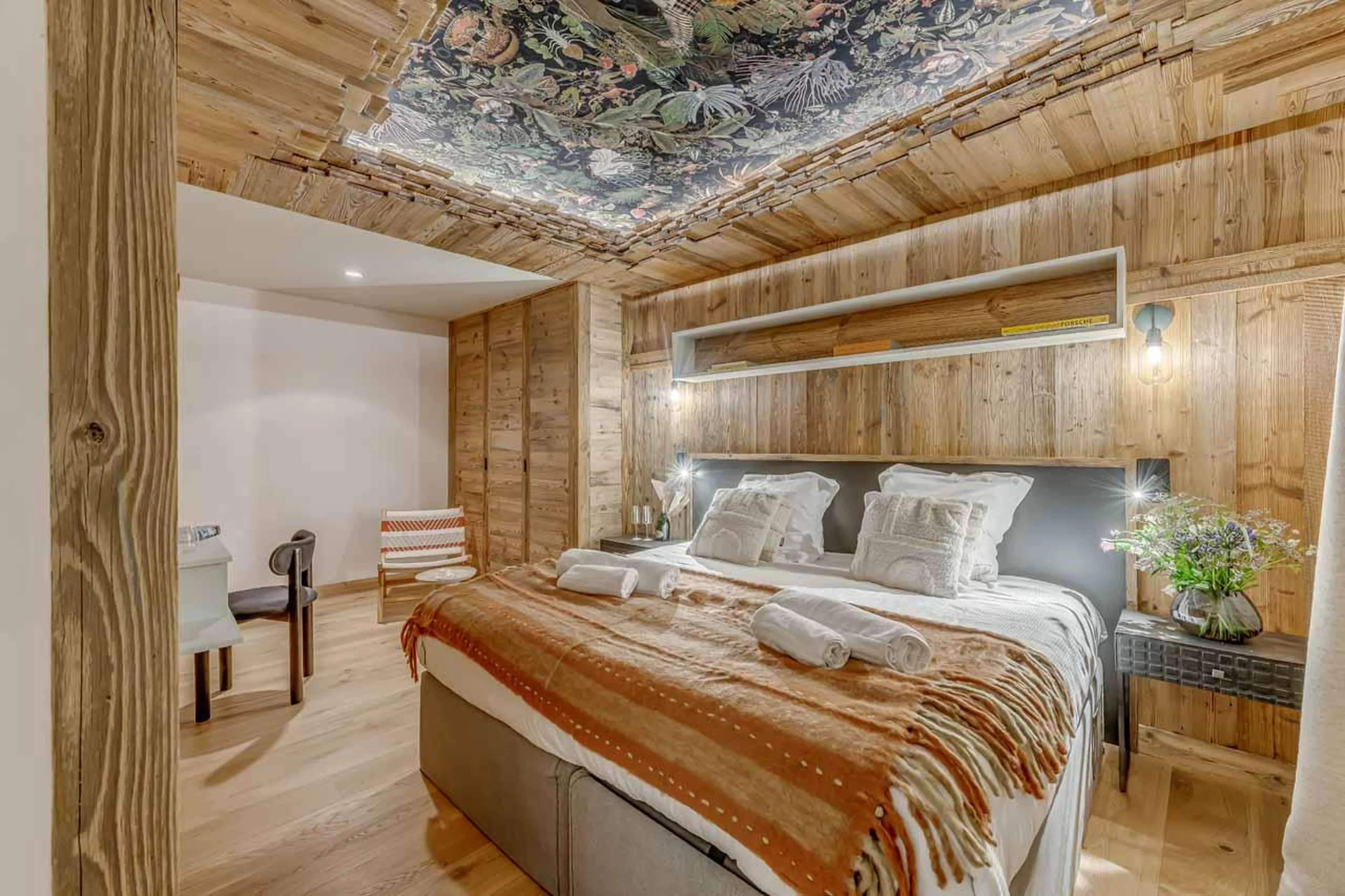 Double bedroom with wooden features in Chalet Sneg, Tignes