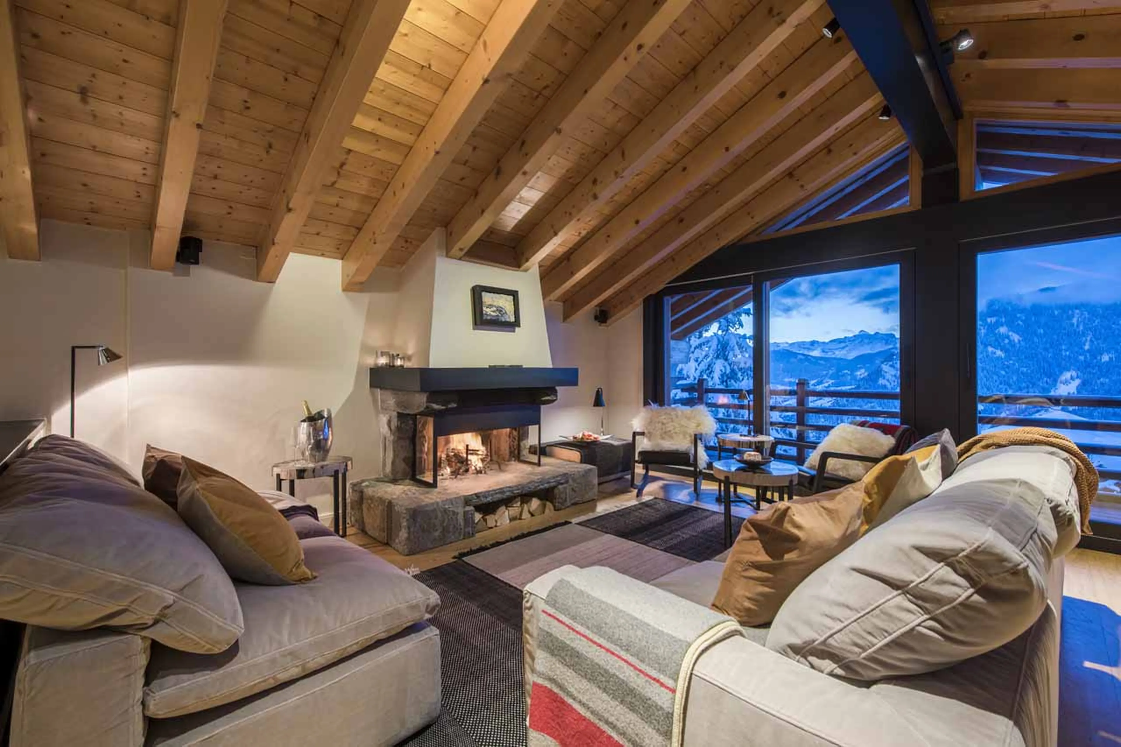 Open fireplace in living room at Chalet Sorojasa in Verbier