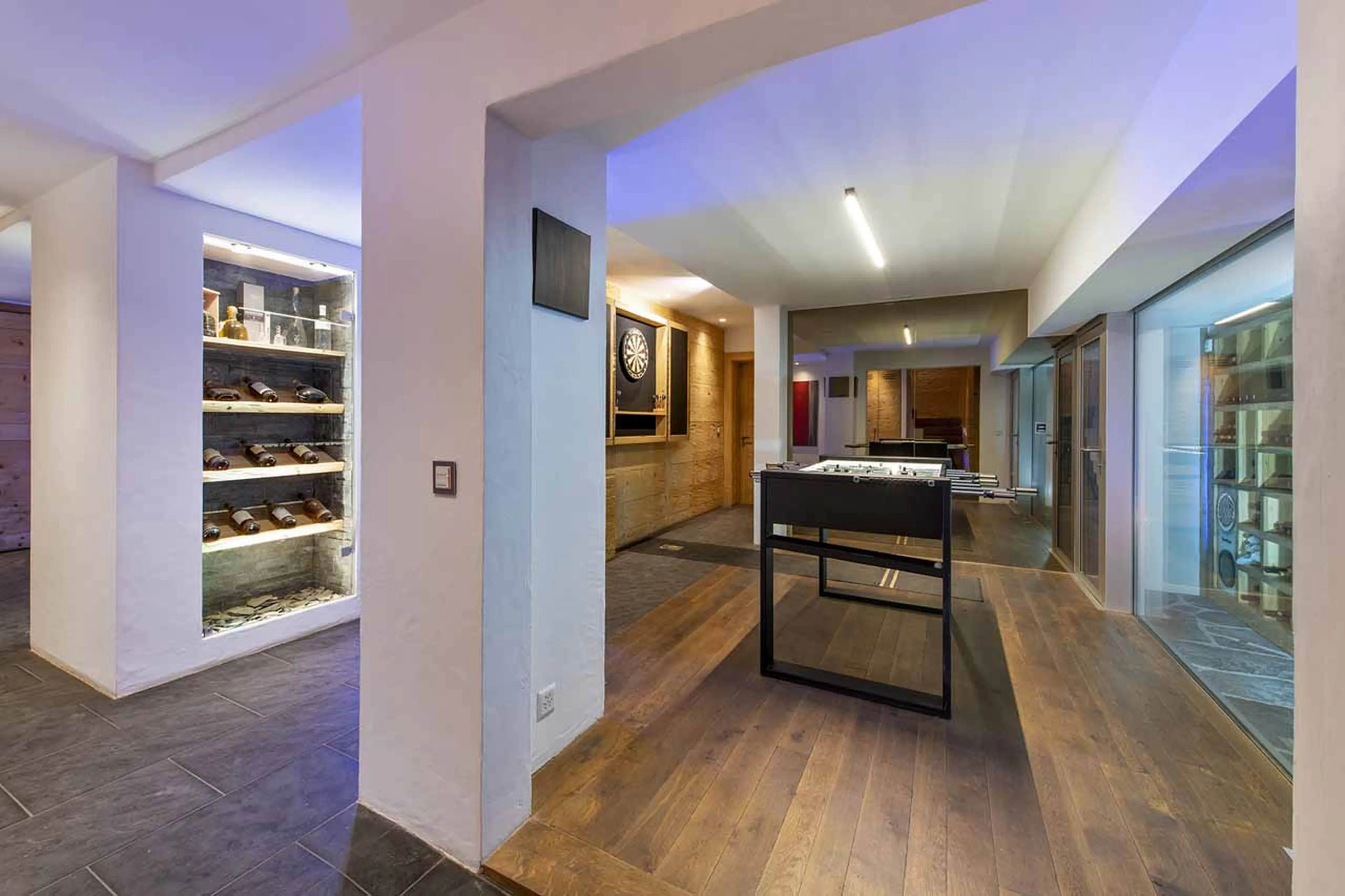 Games room with wine cave at Chalet Spa in Verbier