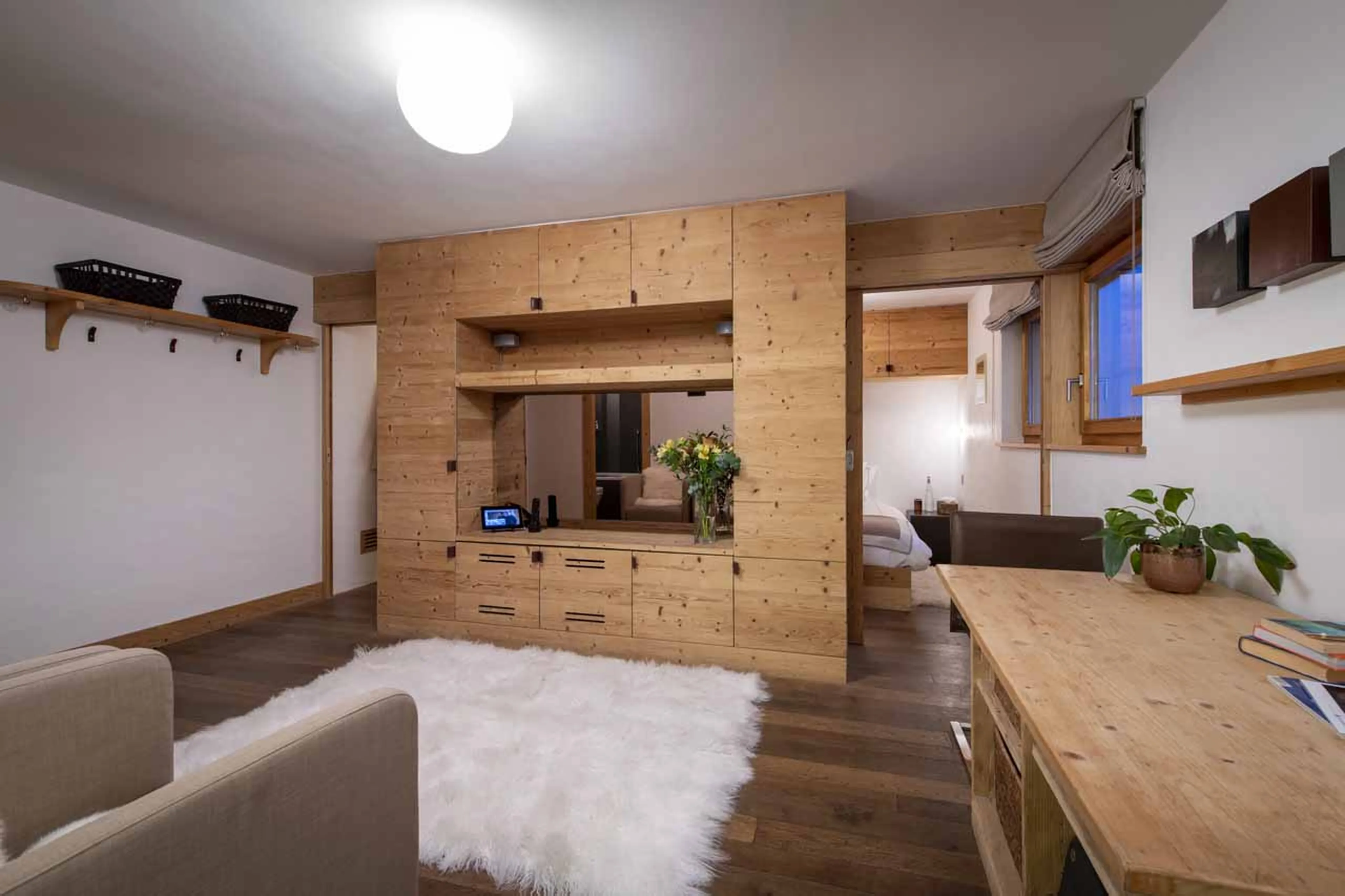 Living area and bedroom in studio of Chalet Spa in Verbier