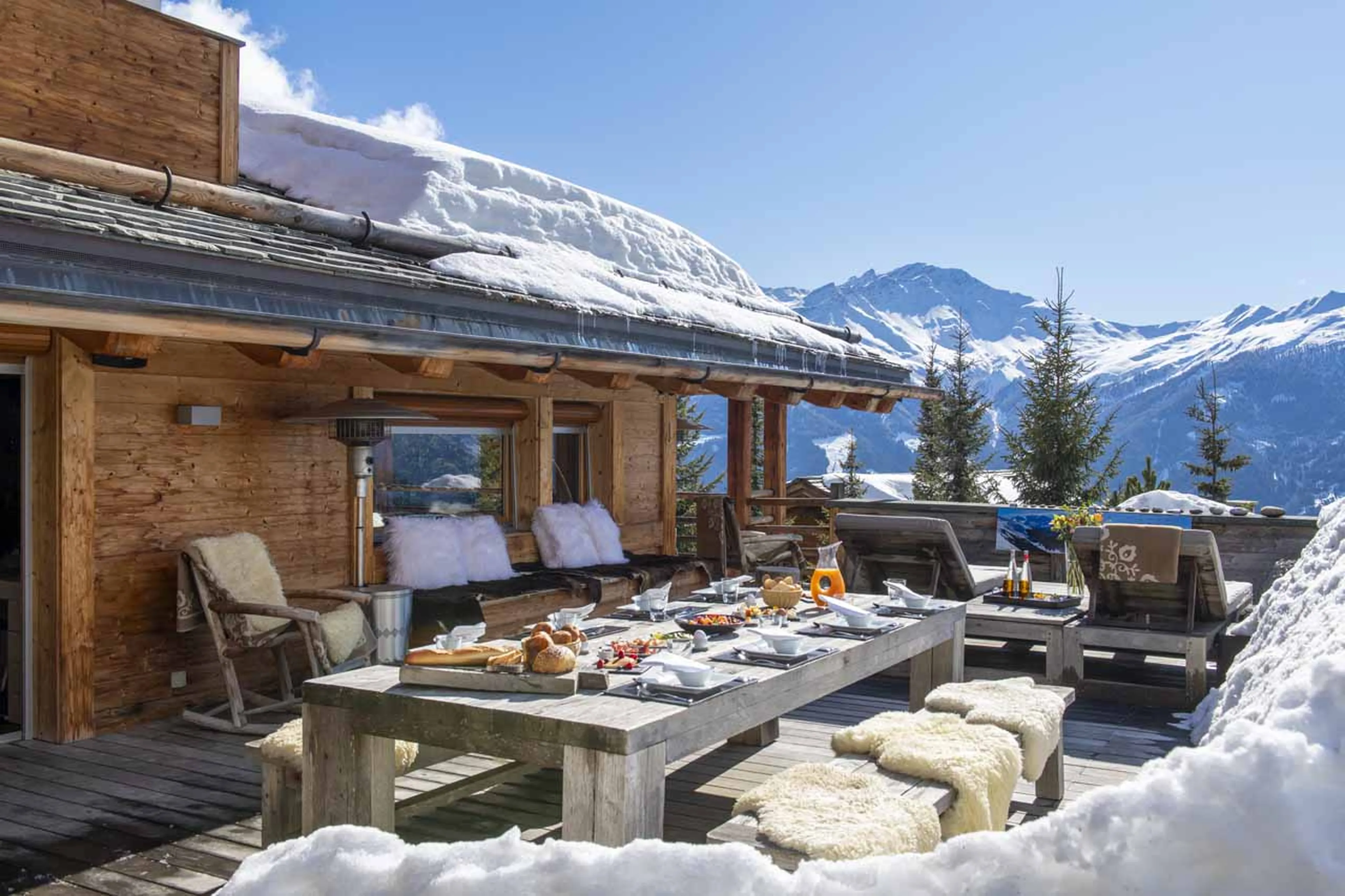 Outdoor dining on terrace at Chalet Spa in Verbier