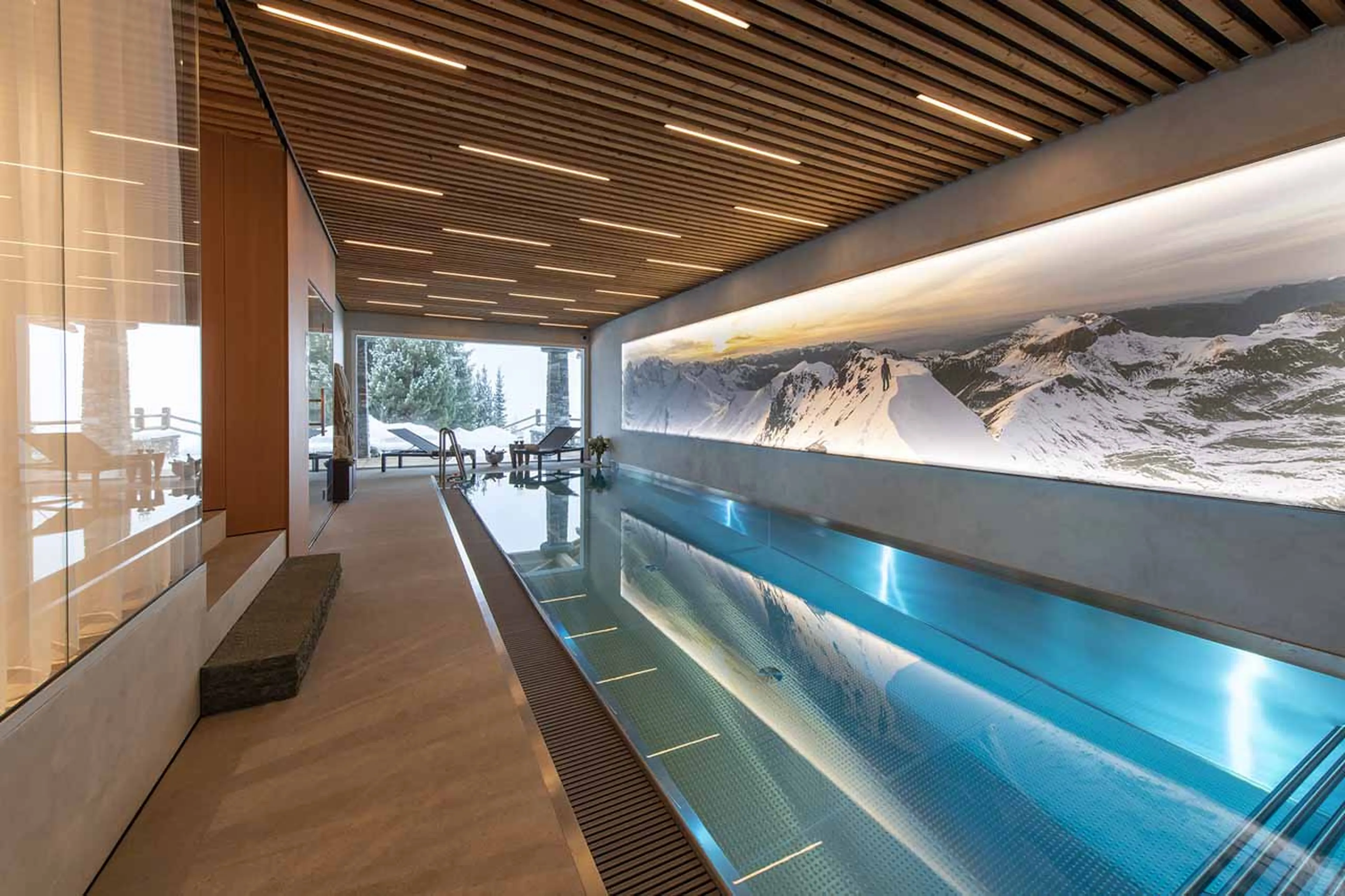 Indoor pool with access to terrace at Chalet Spa in Verbier