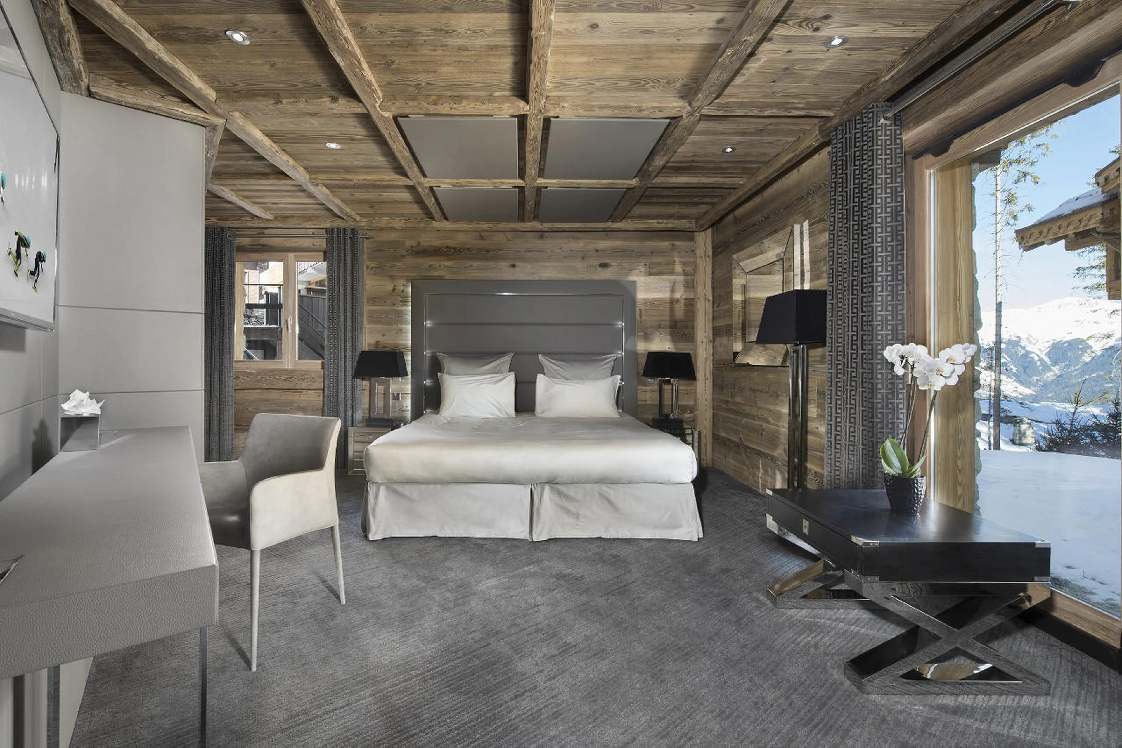 Smartly decked double bed in en-suite bedroom in Chalet Tahoe in Courchevel 1850